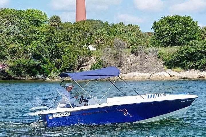 1968 Donzi 18 Classic boat cruising on a scenic waterway with lush greenery.