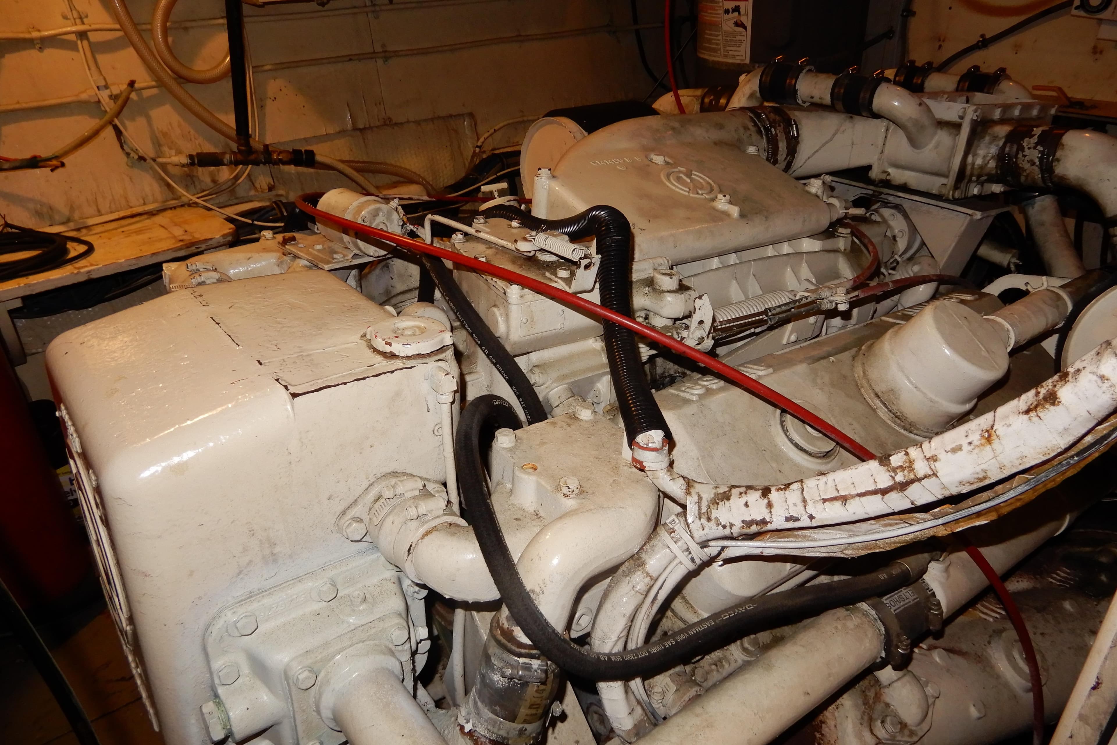 Engine room of a 1979 Hatteras 53 Motor Yacht, showcasing mechanical components.