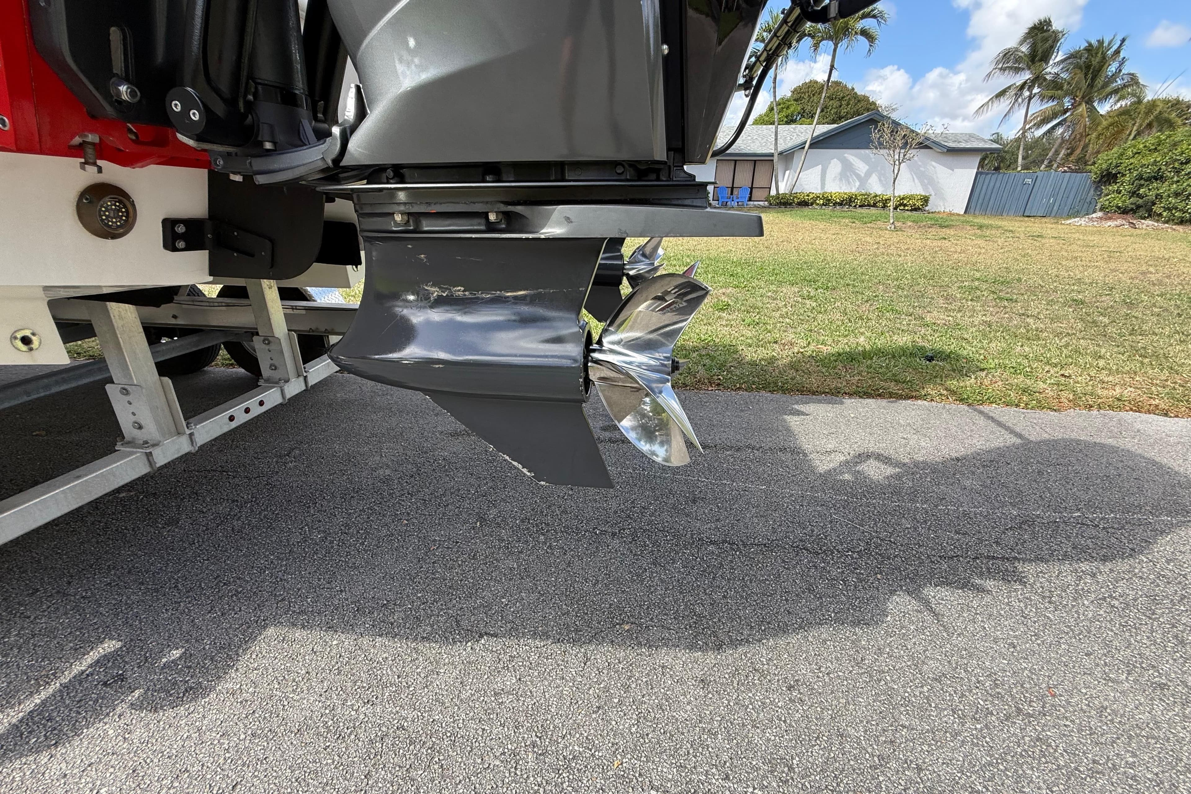 Outboard motor of 2020 HellKats 30 boat on trailer, shiny propeller visible.