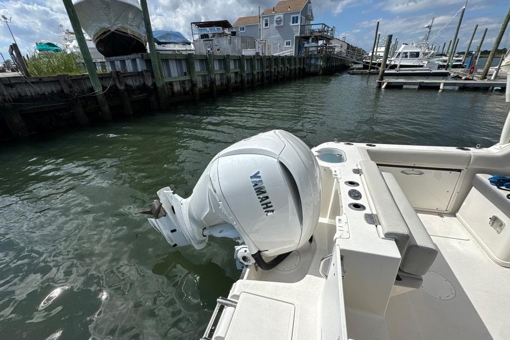 2025 Sailfish 245 DC boat with Yamaha outboard motor docked at marina.