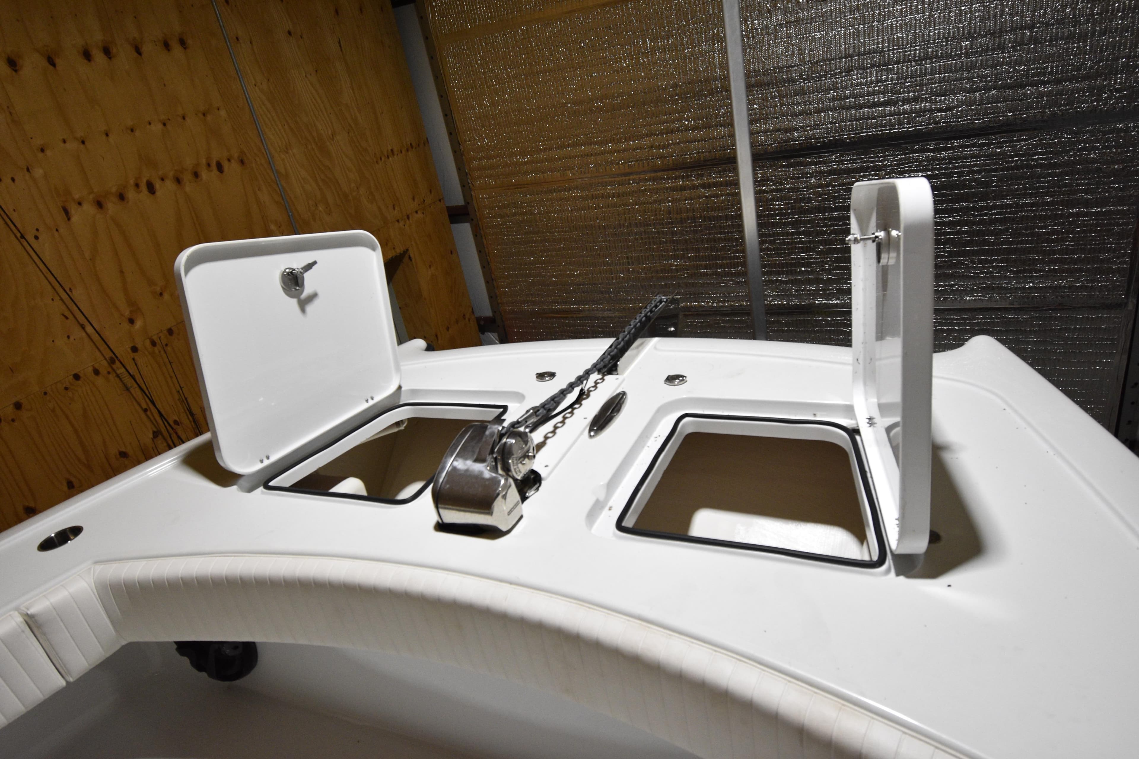 Open storage compartments on a 2016 Freeman 37VH boat deck.