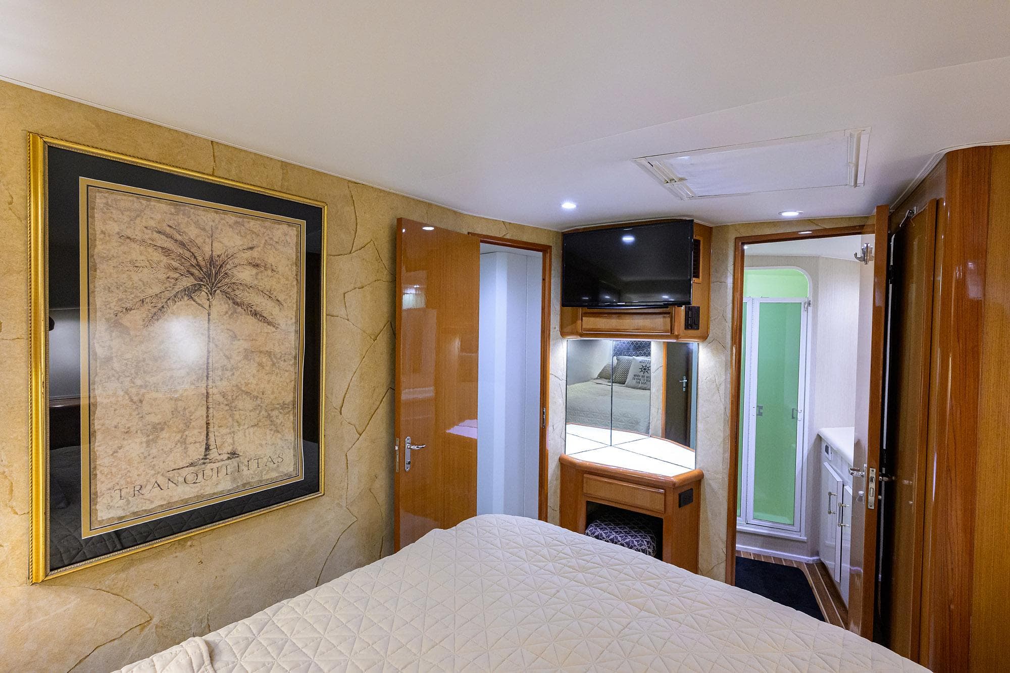 Interior of 2000 Viking 50 Convertible yacht with bedroom, TV, and bathroom.
