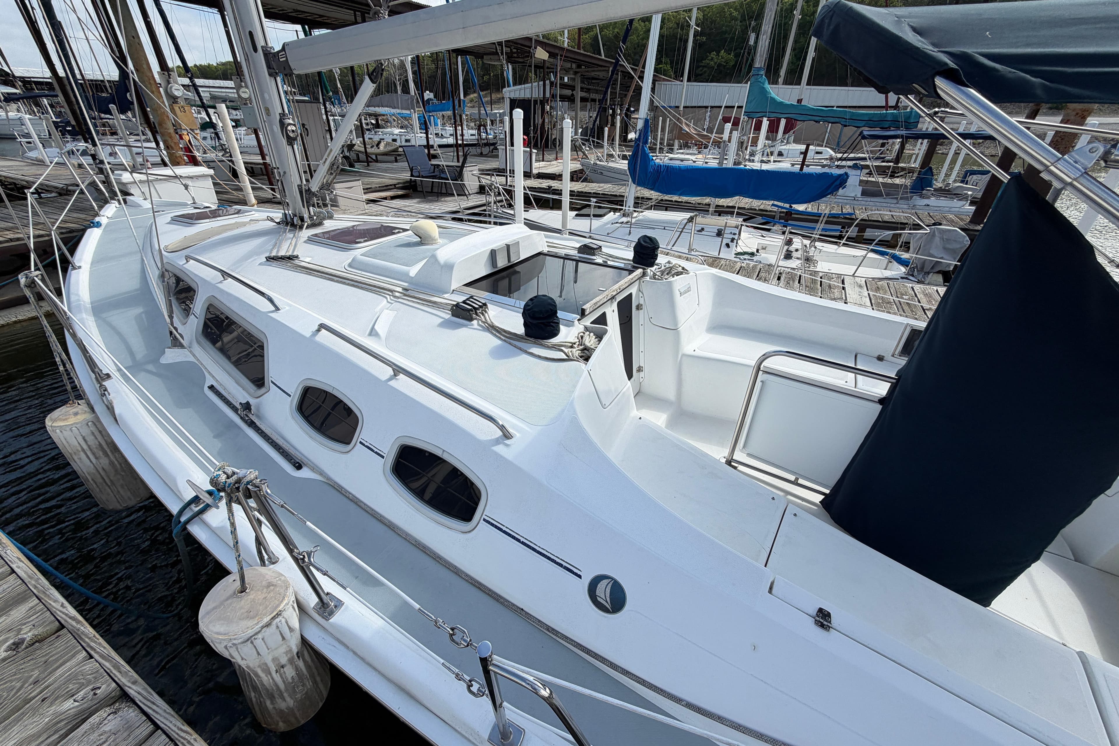 2008 Hunter 36 sailboat docked at marina, featuring sleek white design and spacious deck.