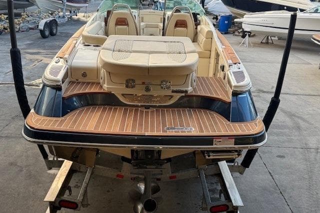 2022 Chris-Craft Launch 25 GT boat on trailer, showcasing elegant design and spacious seating.