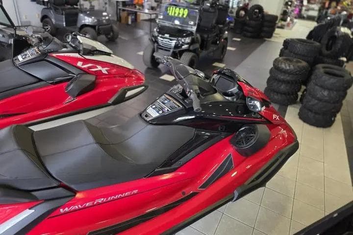 2026 Yamaha WaveRunner FX Cruiser HO in showroom, red and black design, displayed with other vehicles.
