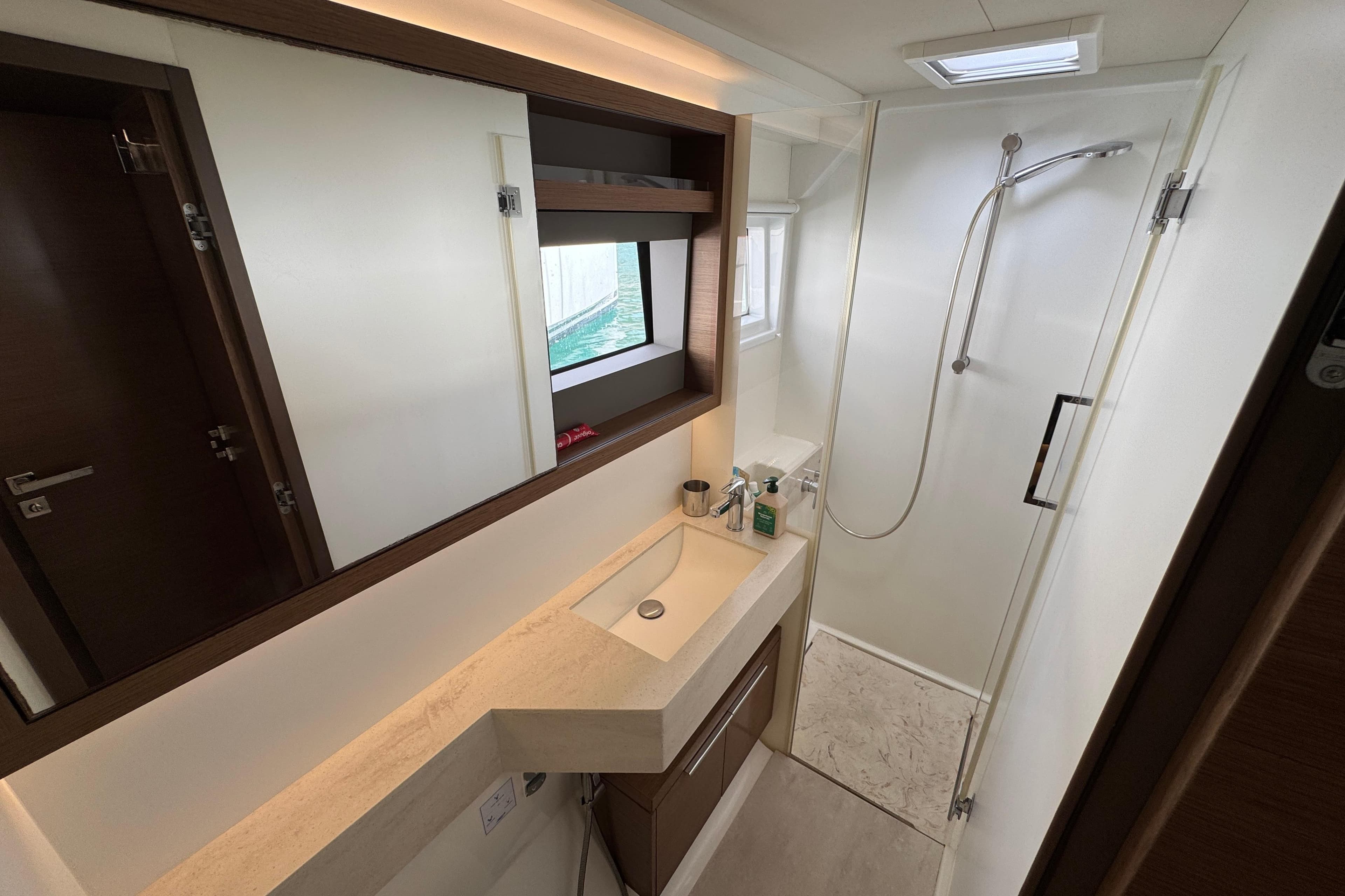 Modern bathroom interior on a 2021 Lagoon 50 yacht, featuring sleek design and shower area.