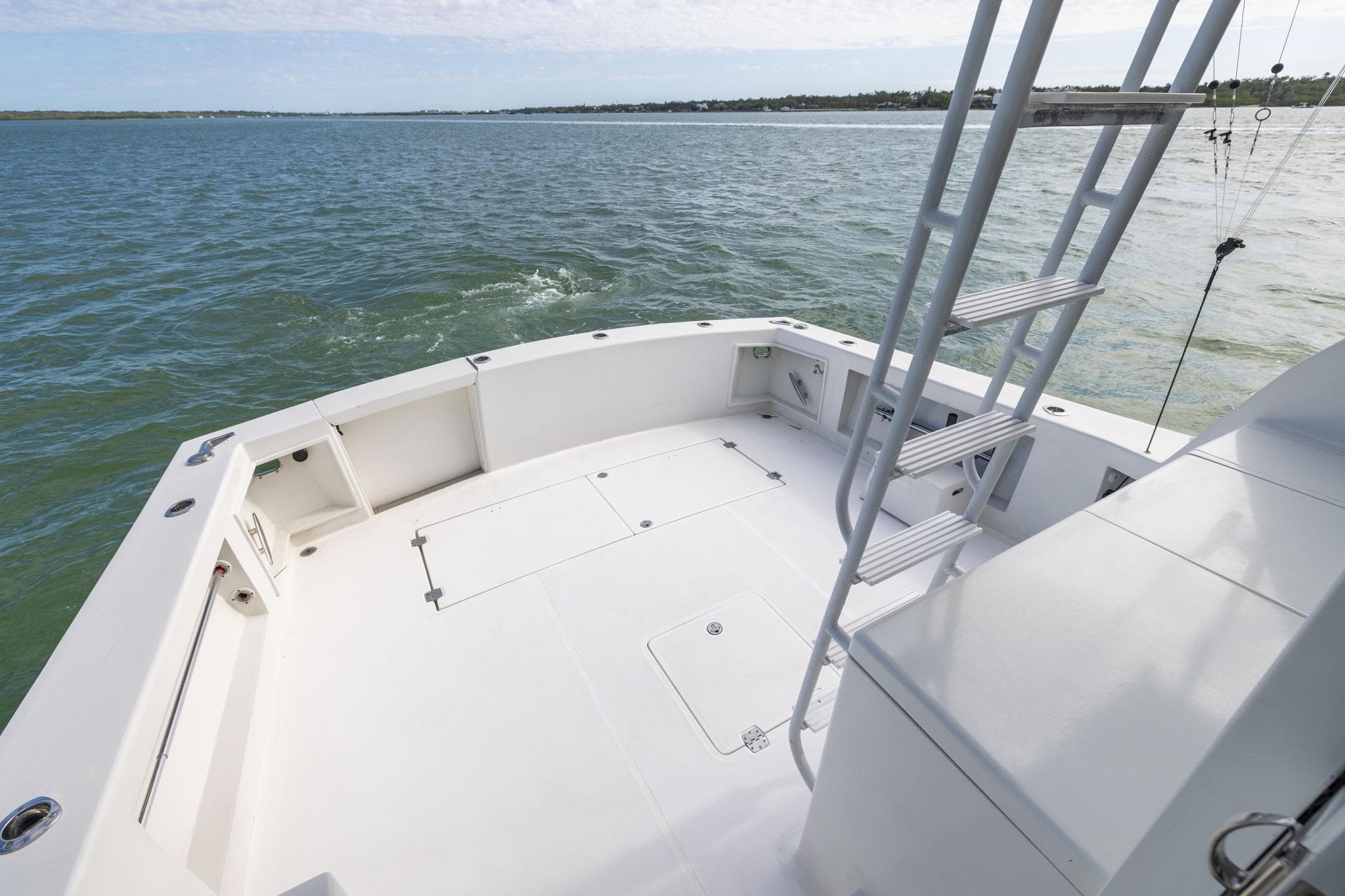 1984 Ocean Yachts 55 Super Sport boat deck with ladder, overlooking calm waters.