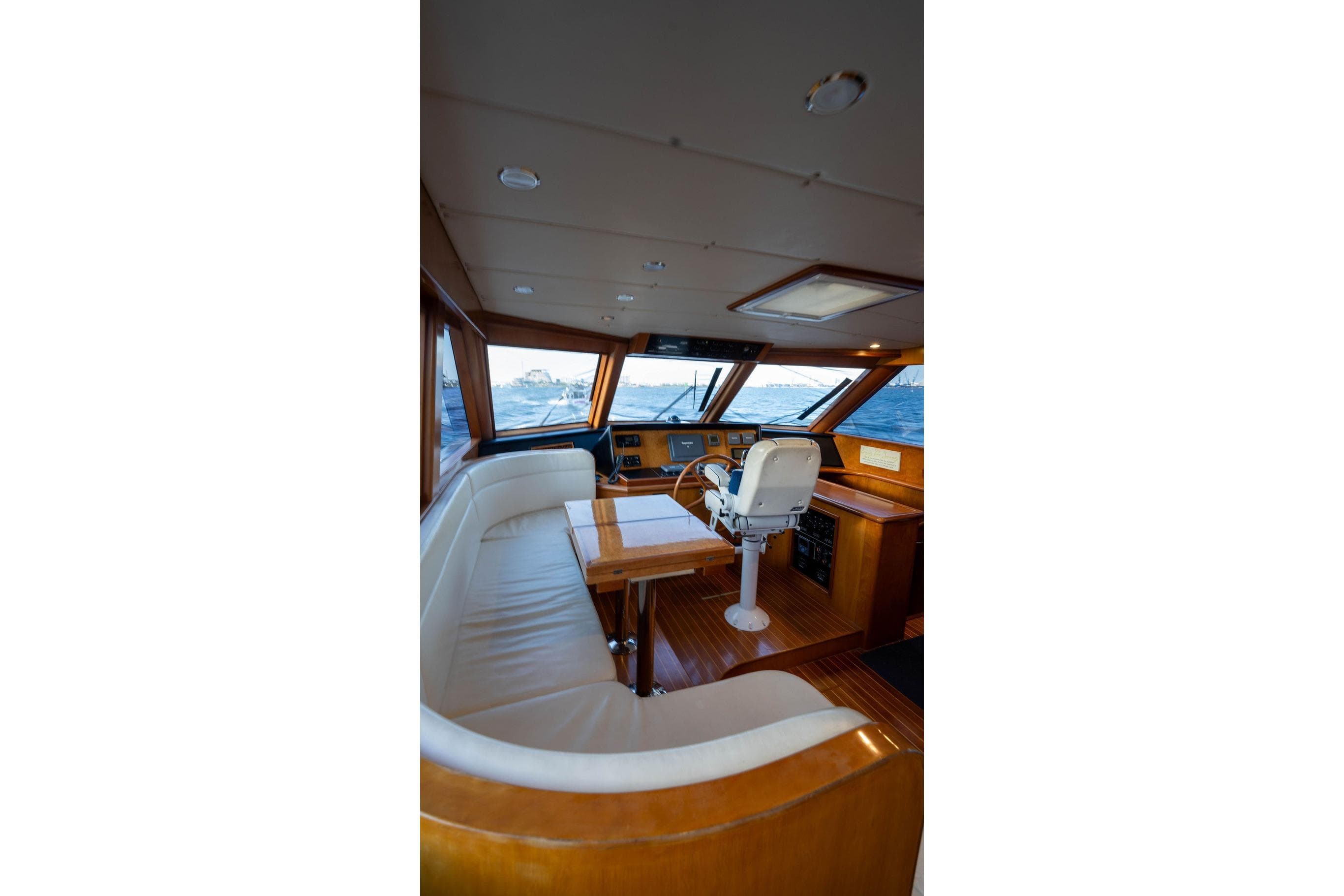 Luxurious interior of 2005 Symbol 58 Pilothouse yacht with helm and seating area.