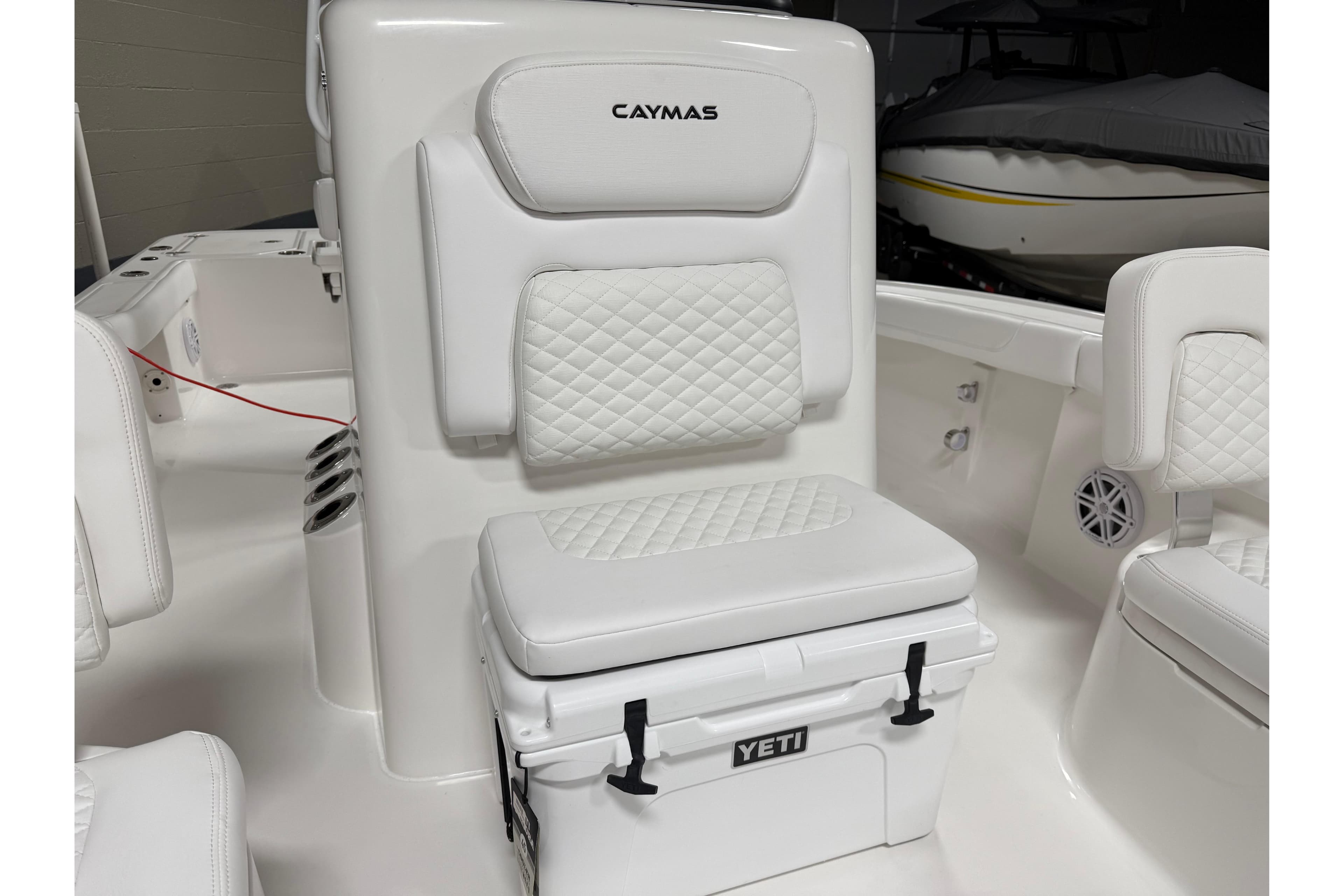 2026 Caymas 24 HB boat interior with white cushioned seating and Yeti cooler.