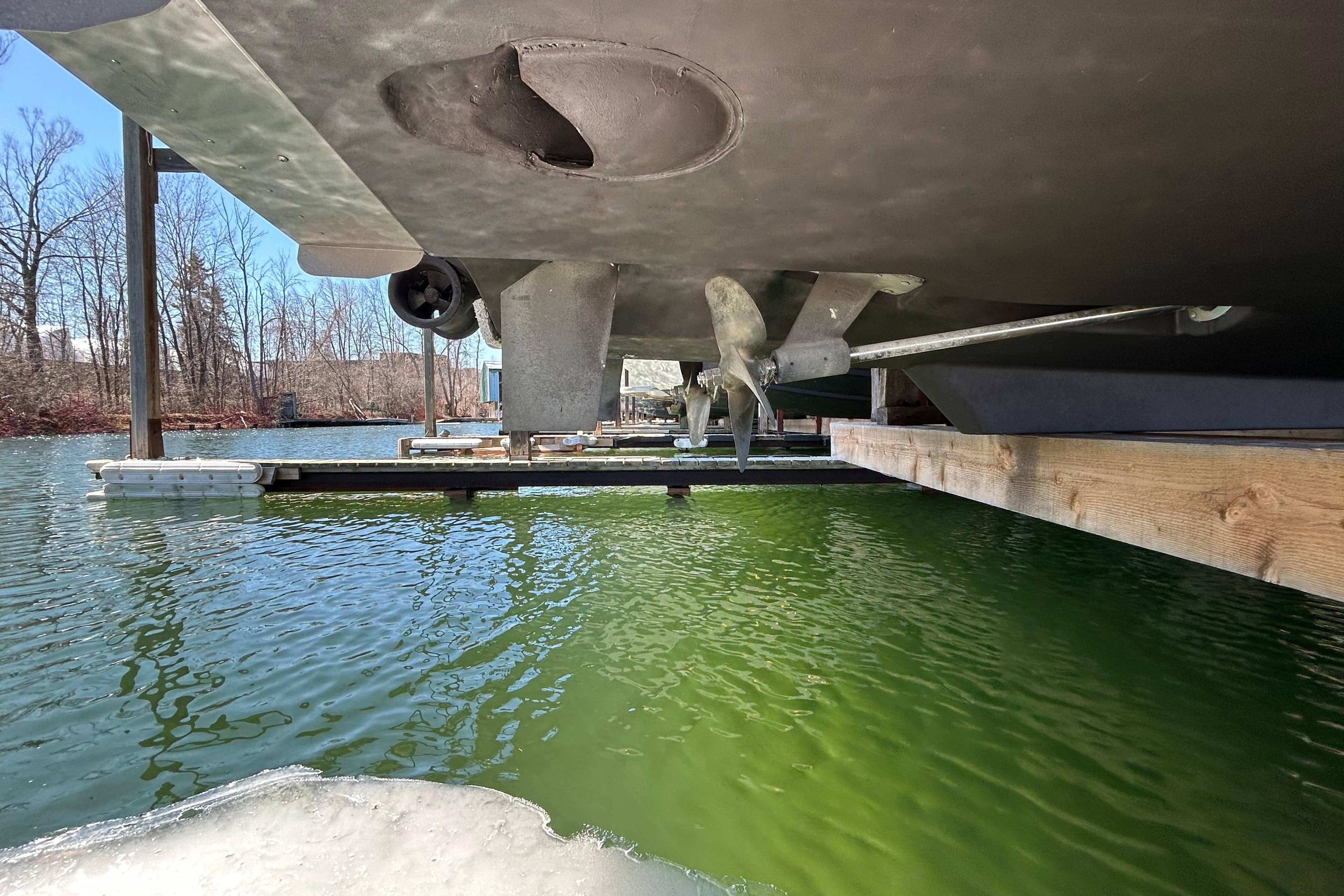 Underwater view of 2009 Meridian 391 Sedan propeller and hull in a marina setting.