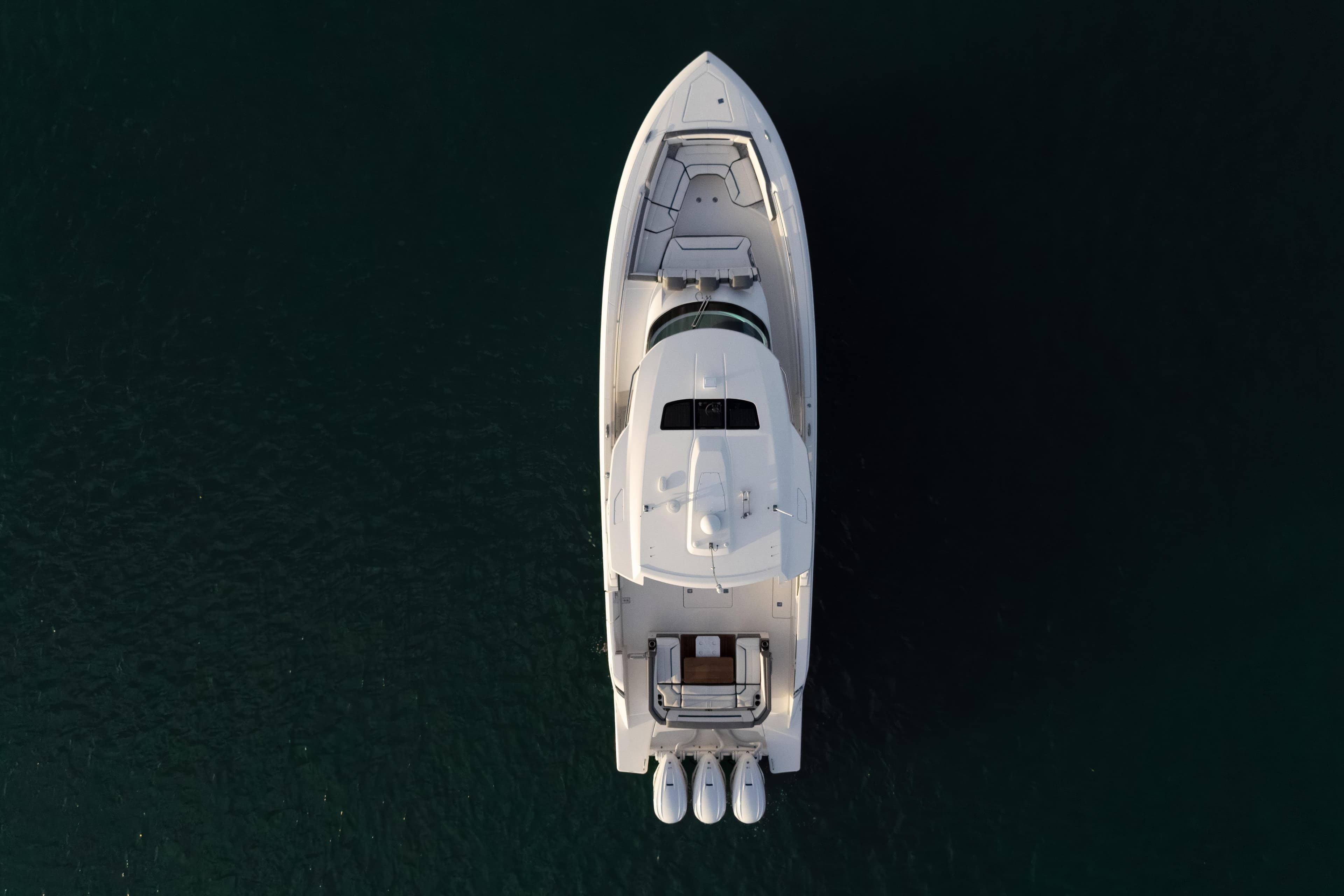 Aerial view of 2020 Tiara Yachts 43 LS on dark water.