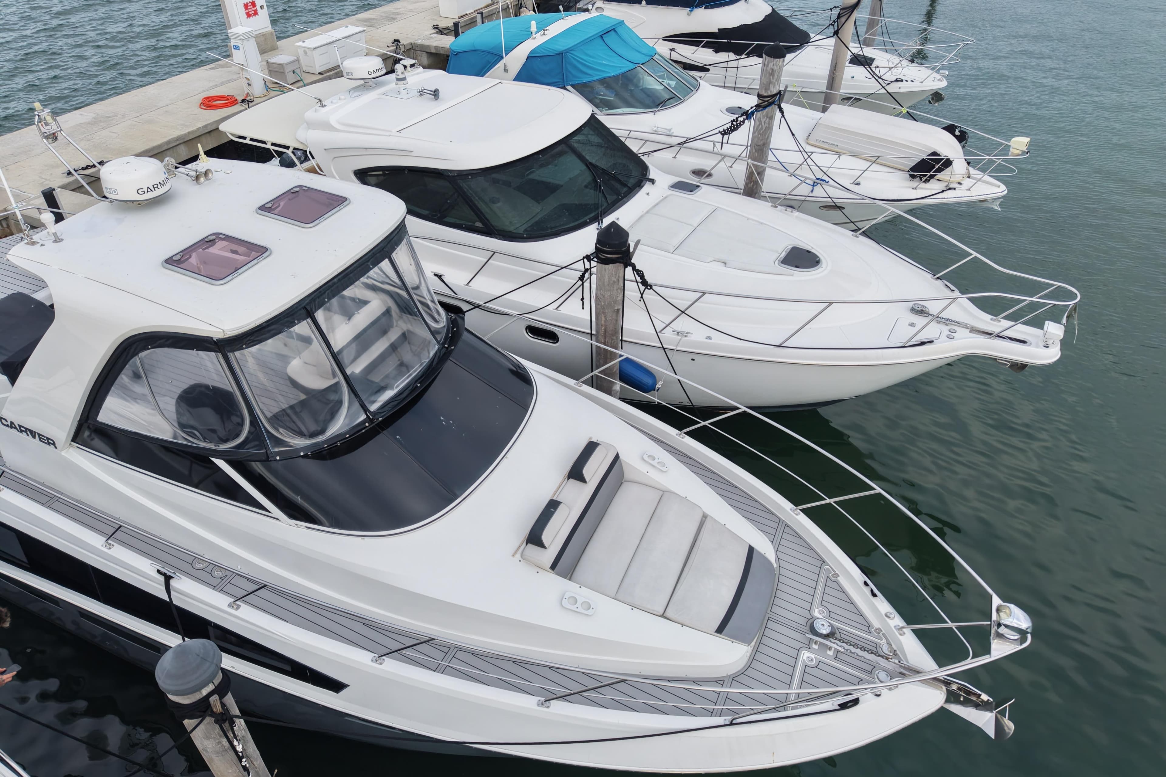2009 Carver 44 Sojourn yacht docked alongside other boats in a marina.