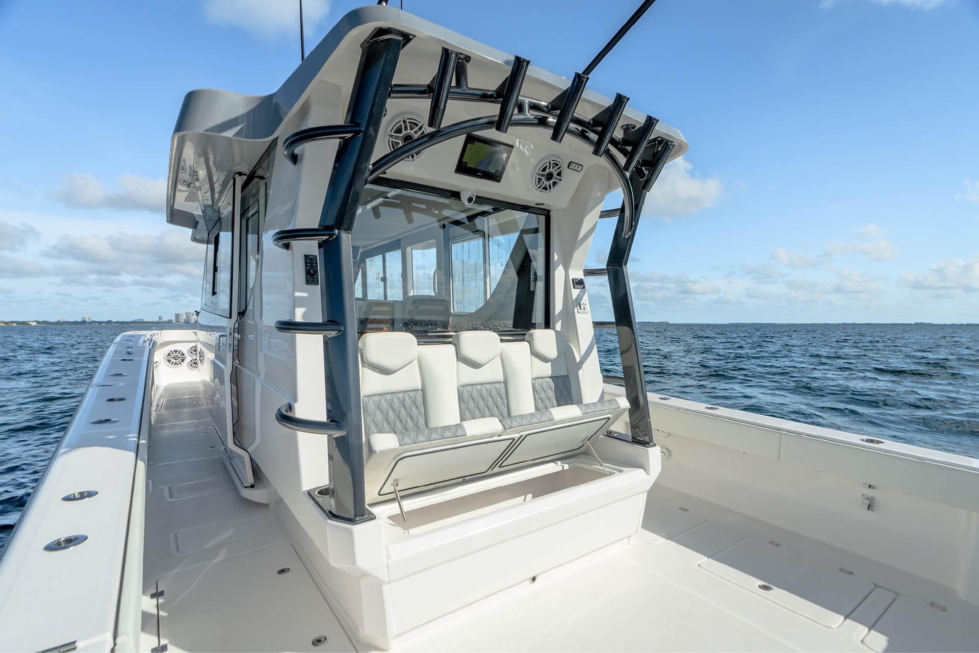 2026 Invincible 46 Pilothouse boat on open water, showcasing sleek design and seating.