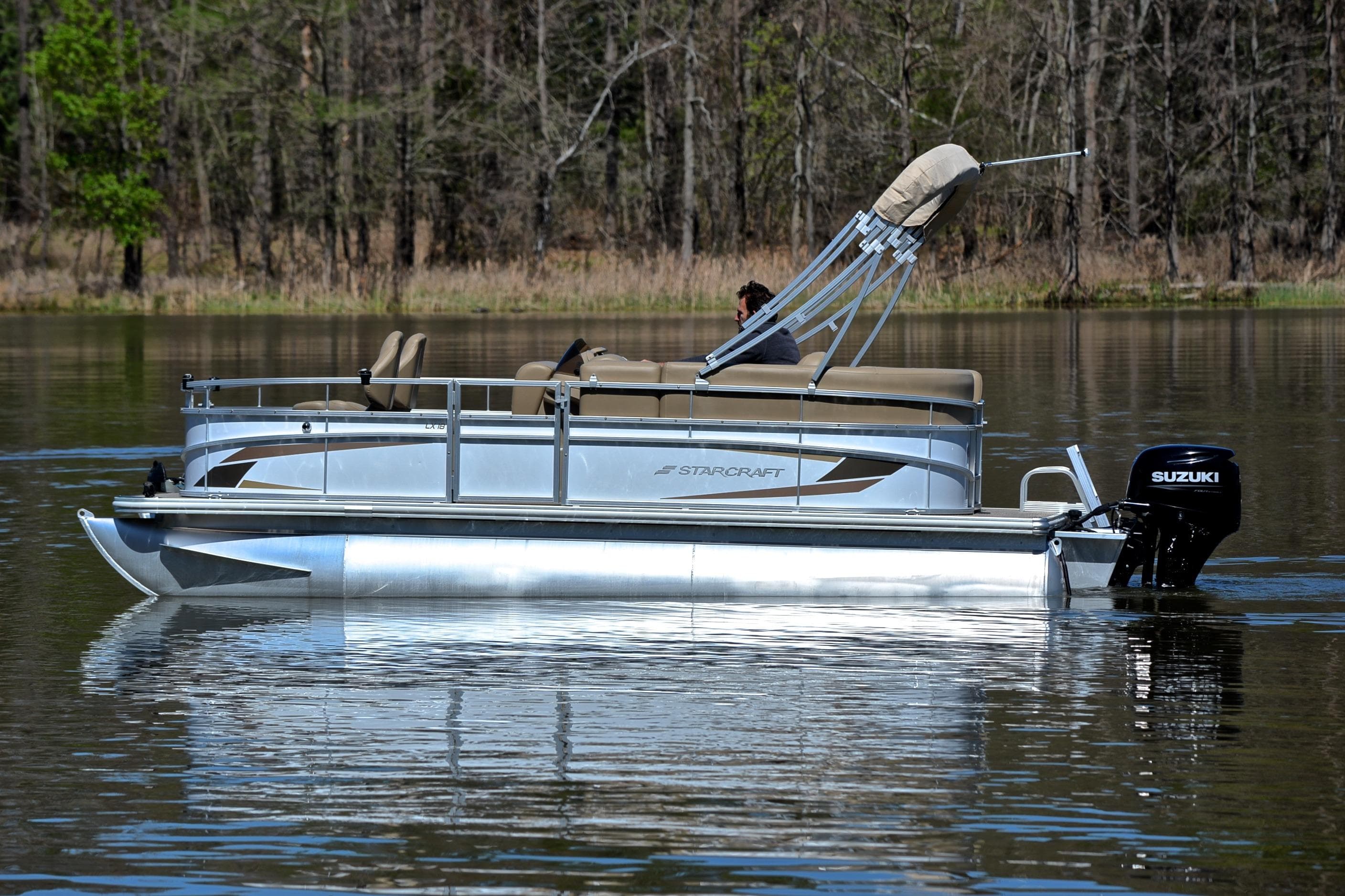 2023 Starcraft EX 18 F pontoon boat on a calm lake.