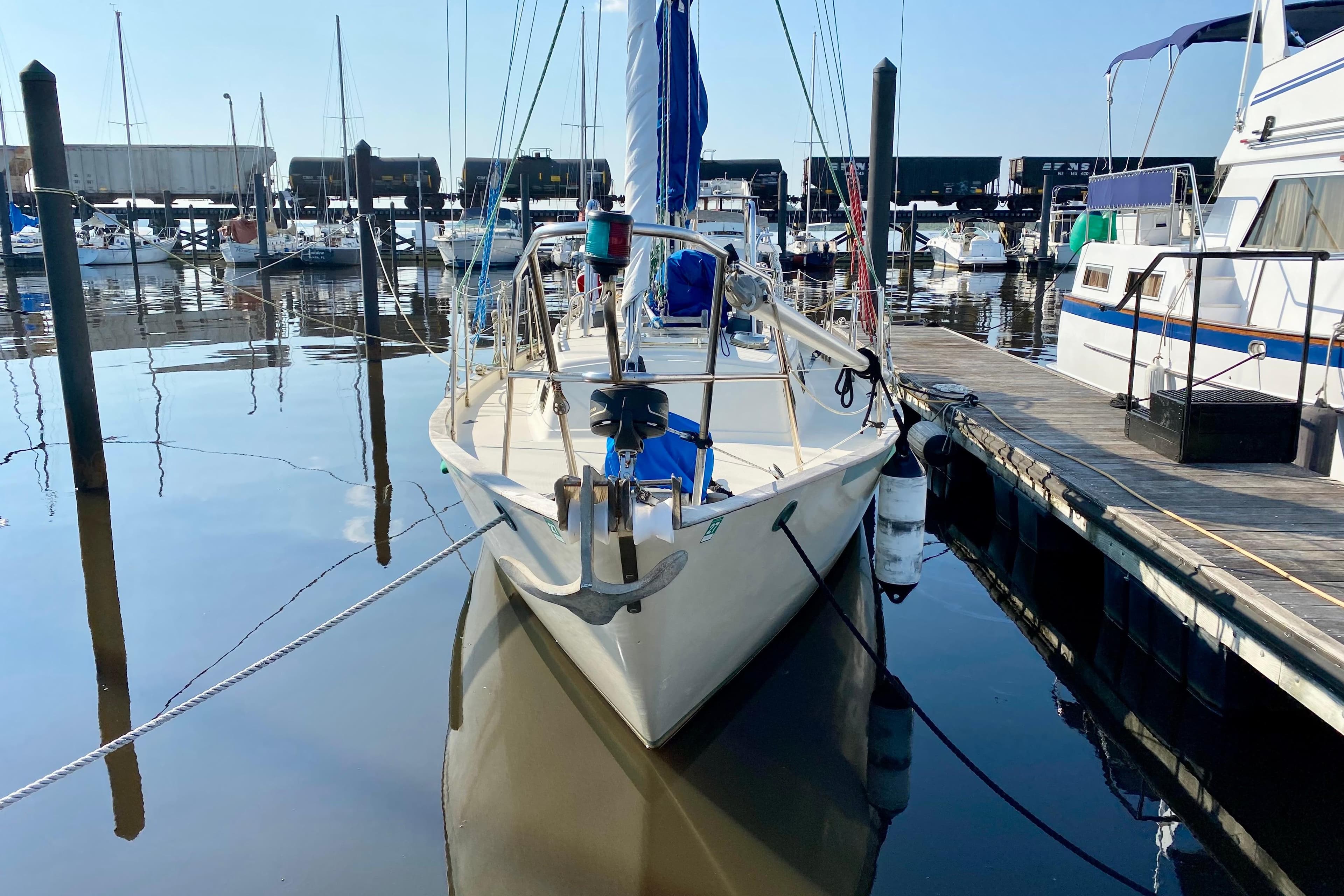 1993 Pacific Seacraft 34 sailboat docked at marina, calm water reflections.