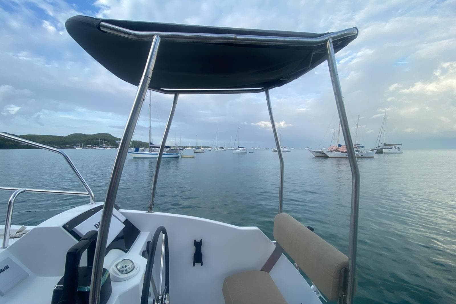 Nautitech 40 Open 2021 catamaran helm with ocean view and anchored boats.