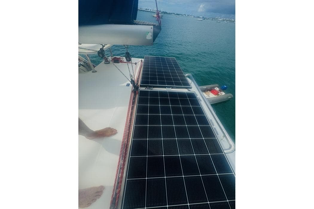 Solar panels on a 2011 Leopard 39 catamaran, docked in a serene harbor.