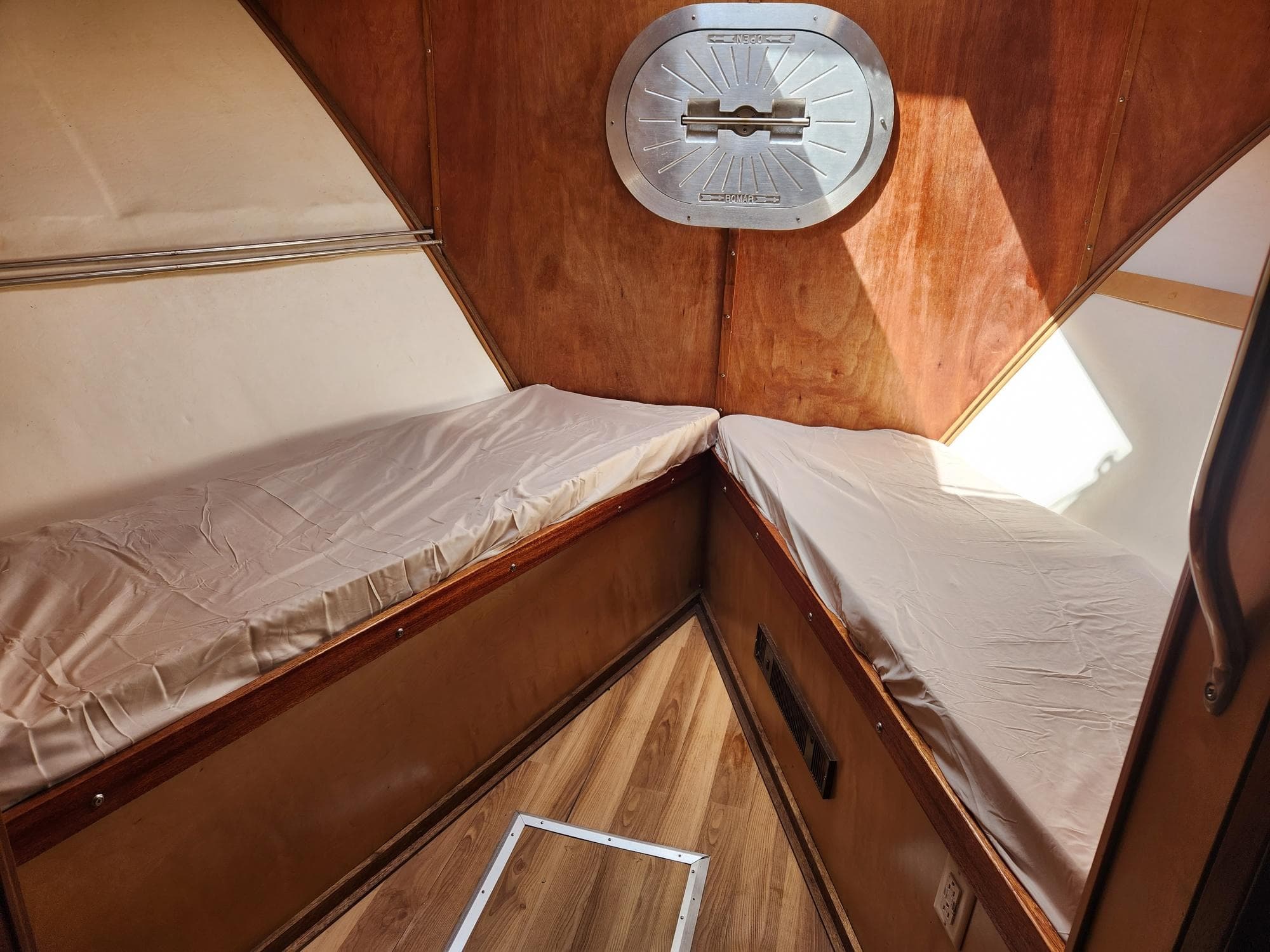 Cozy cabin interior of 1980 Tuna Rose Brothers boat with wooden finish and twin beds.