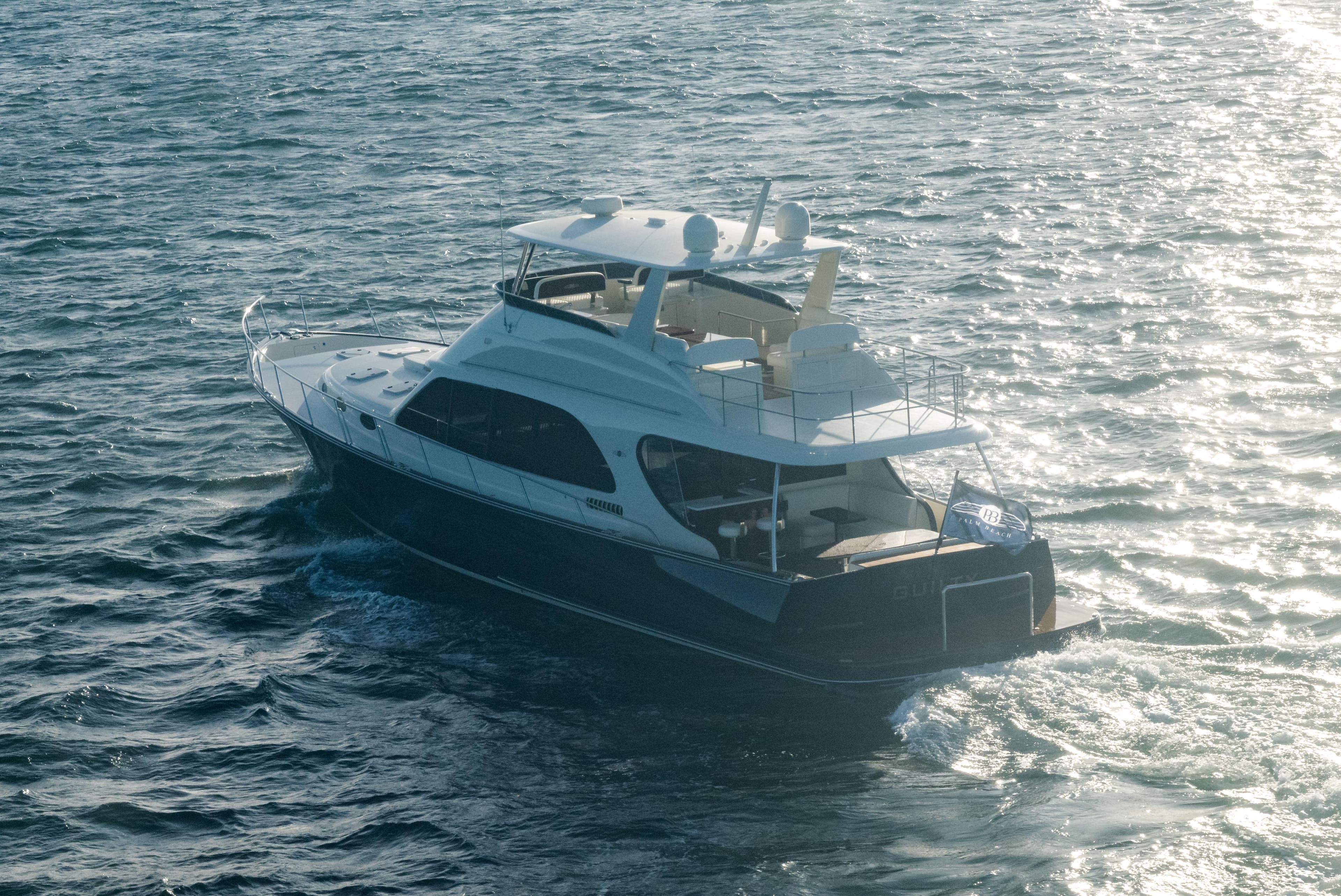 2026 Palm Beach Motor Yachts PB70 cruising on open water, showcasing luxury design.