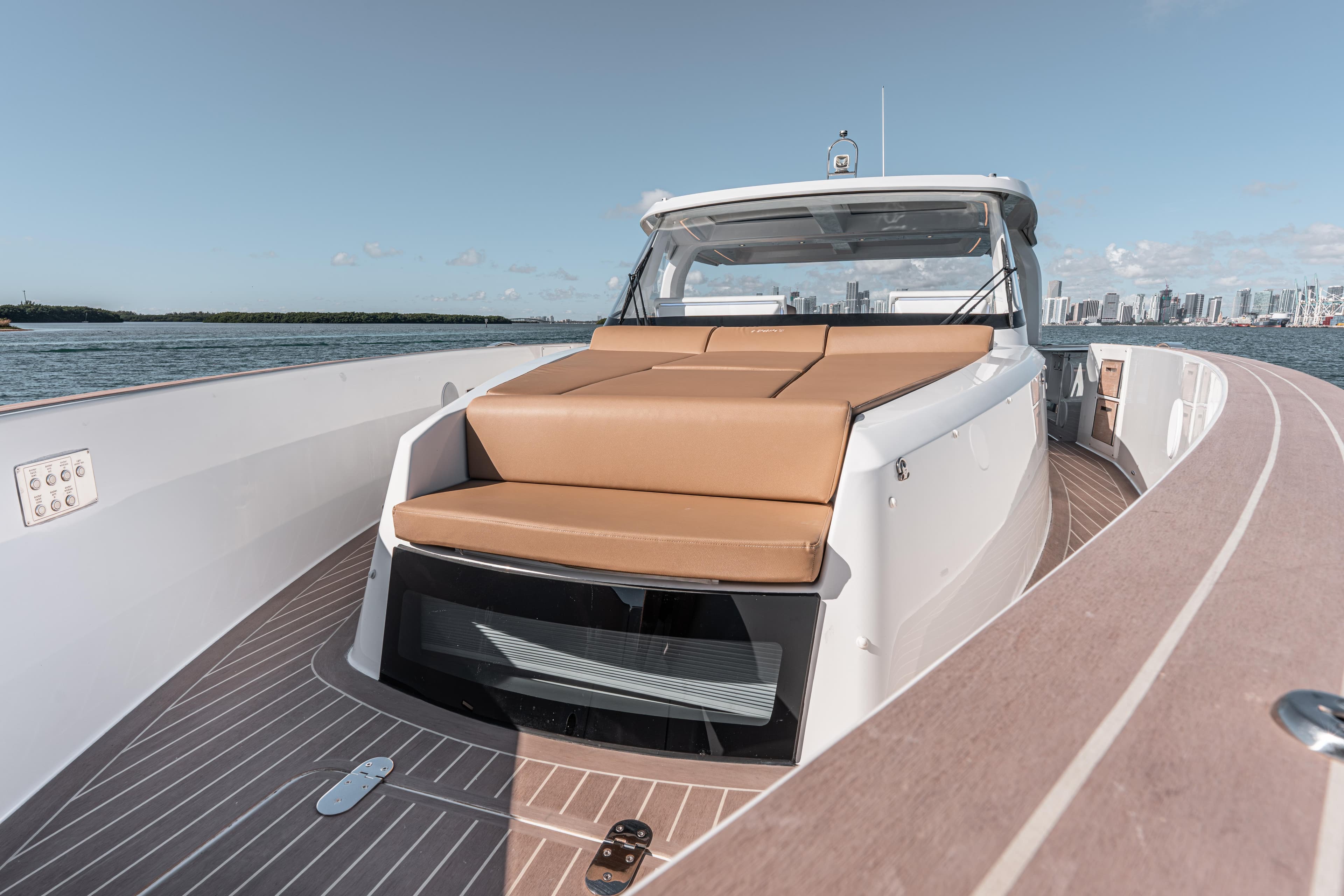 2024 Fjord Boats 53XL luxury yacht with spacious deck and sleek design on open water.
