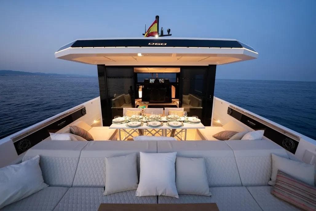Luxurious 2026 De Antonio Yachts D60 with elegant dining setup at sunset.