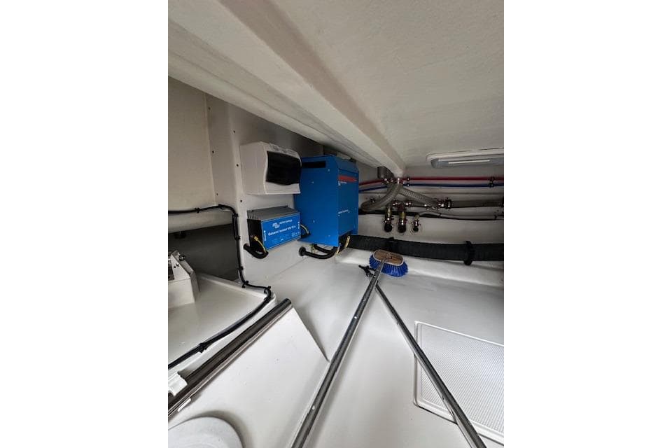 Engine room of 2022 Nordhavn 41 yacht with blue equipment and pipes.