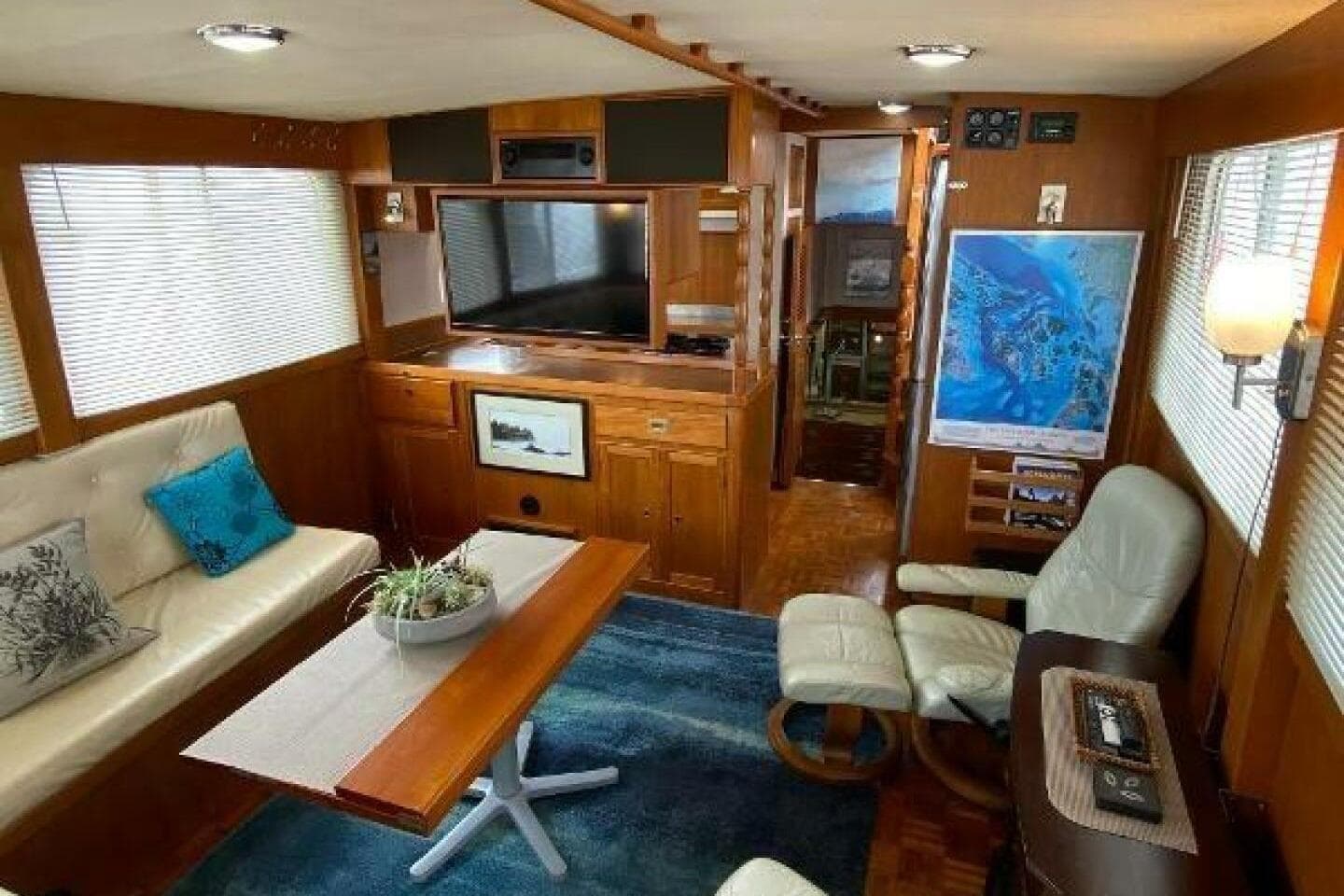 Interior of 1973 Grand Banks 49 Alaskan yacht with cozy seating and wooden decor.