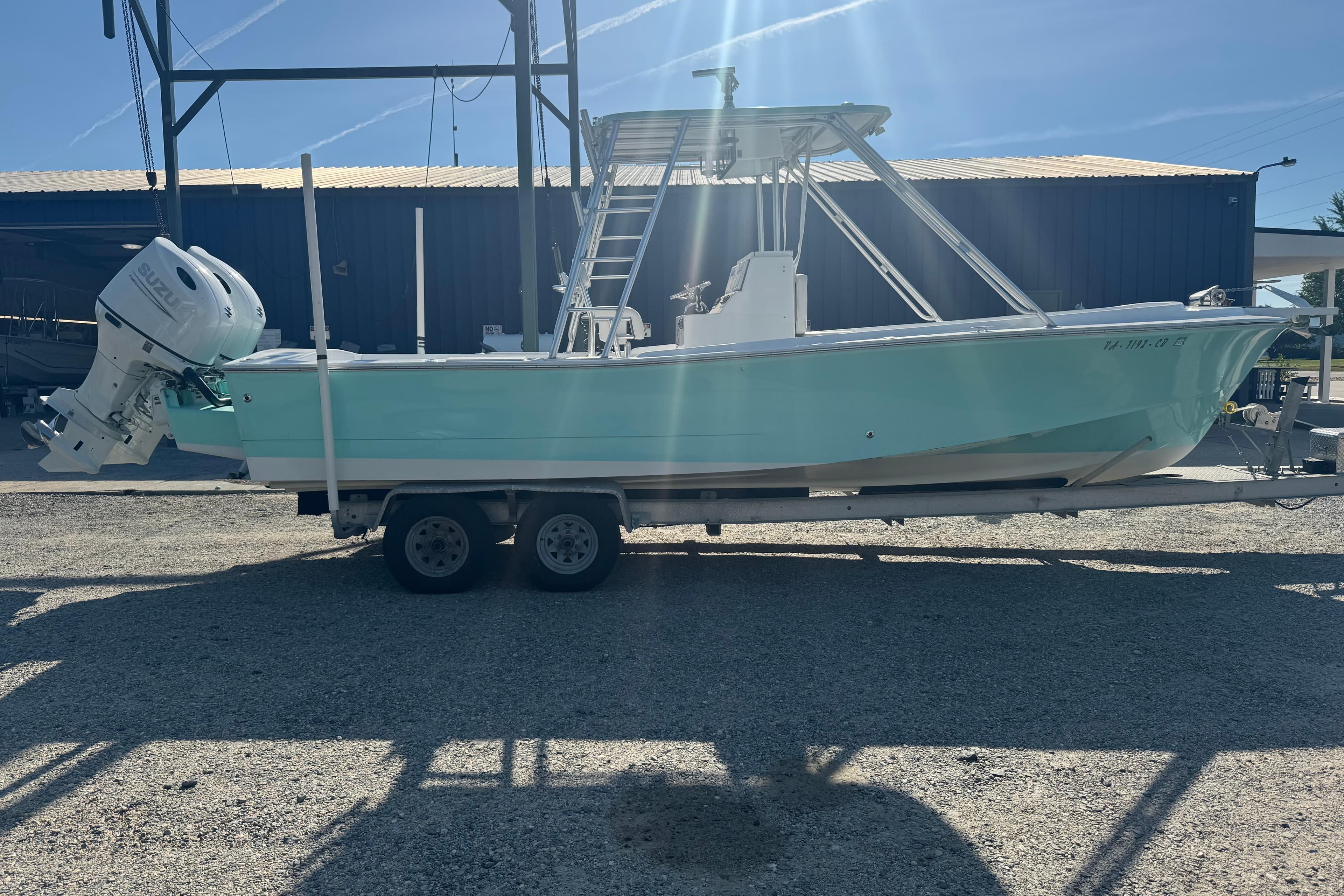 1974 Boca Grande 26 boat on trailer, featuring a Suzuki outboard motor.