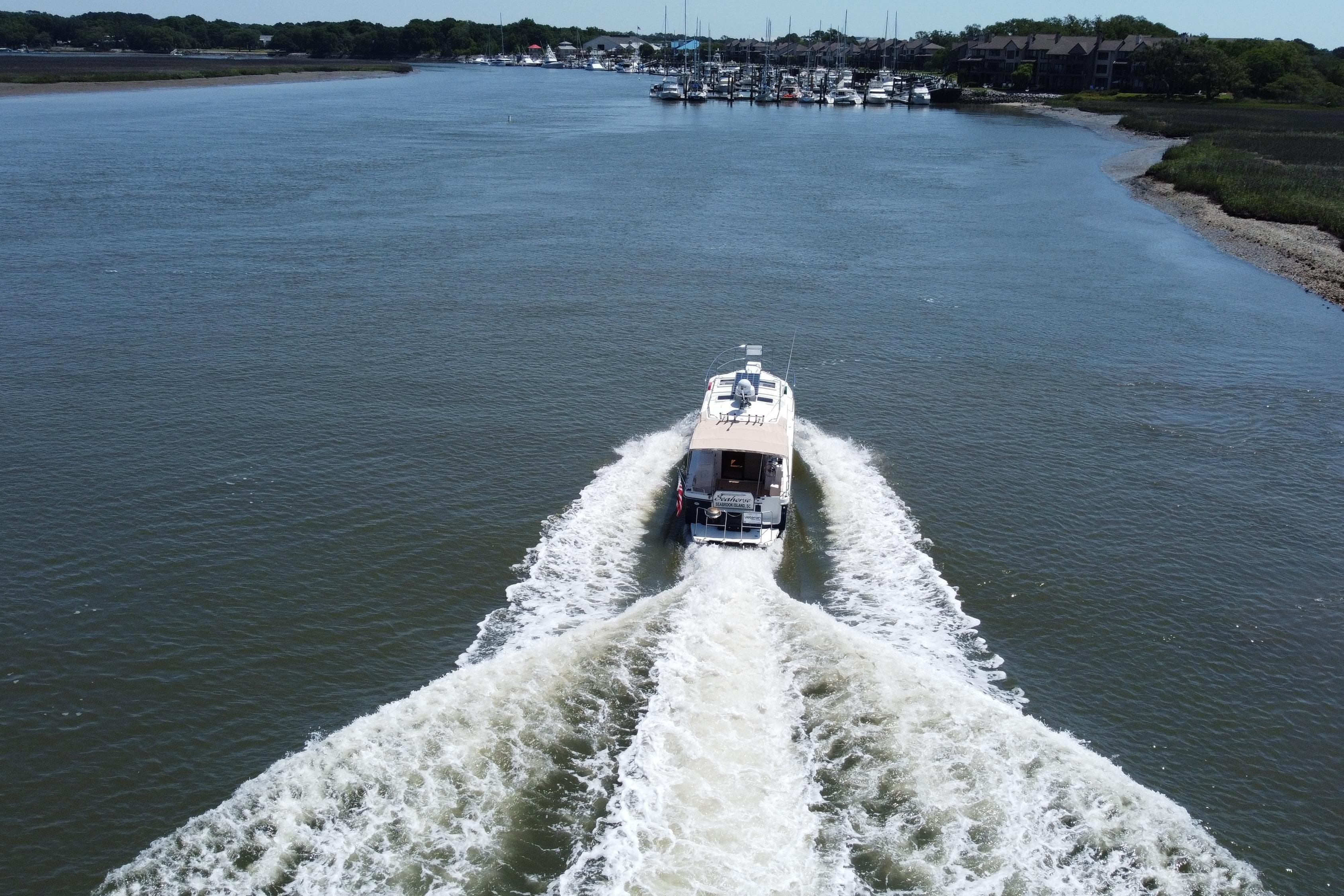 Aerial view of 2016 Cutwater C-28 LE boat cruising on a wide river.