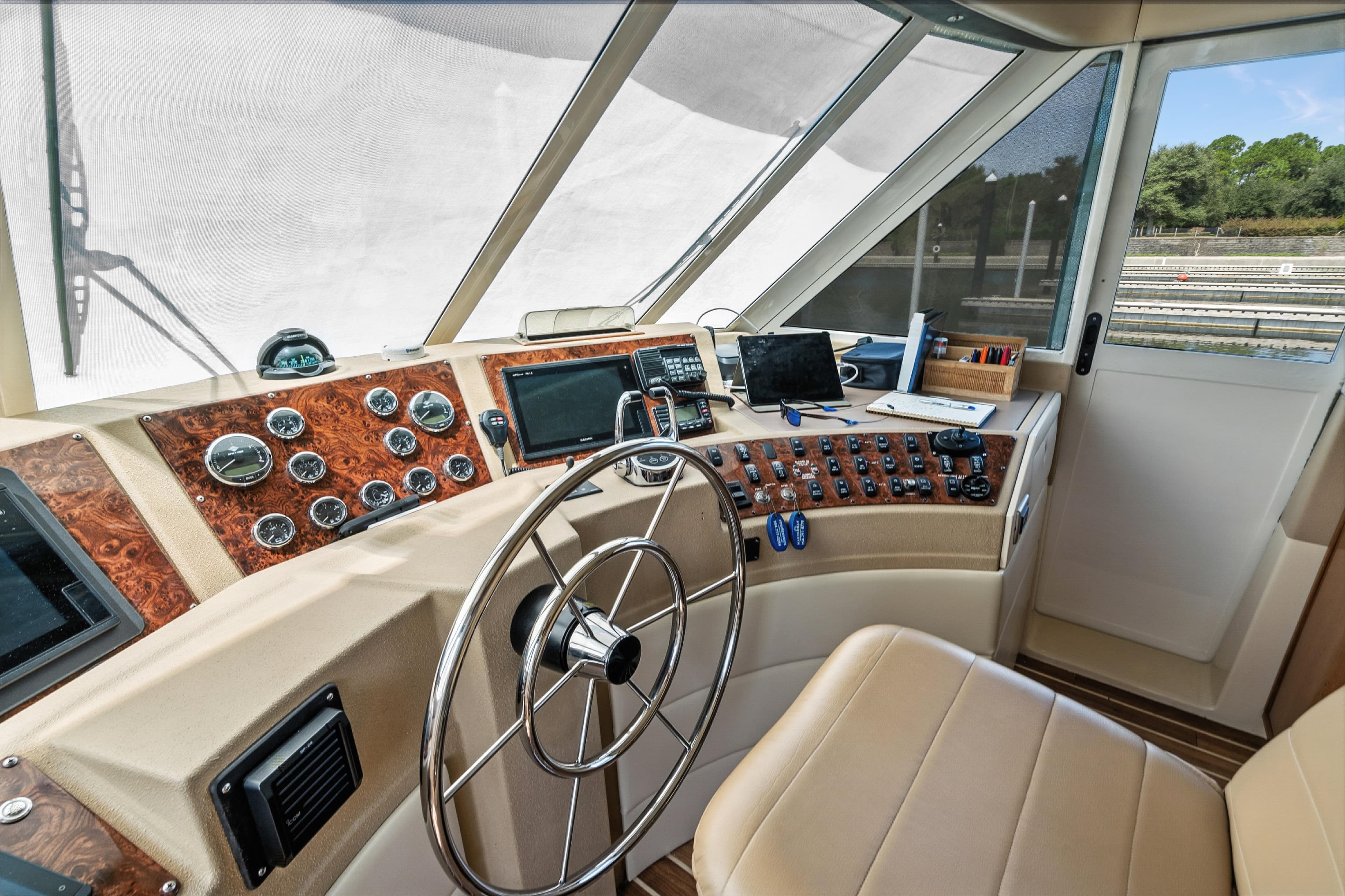 Pilothouse interior of 2007 Meridian 490, featuring steering wheel and navigation instruments.