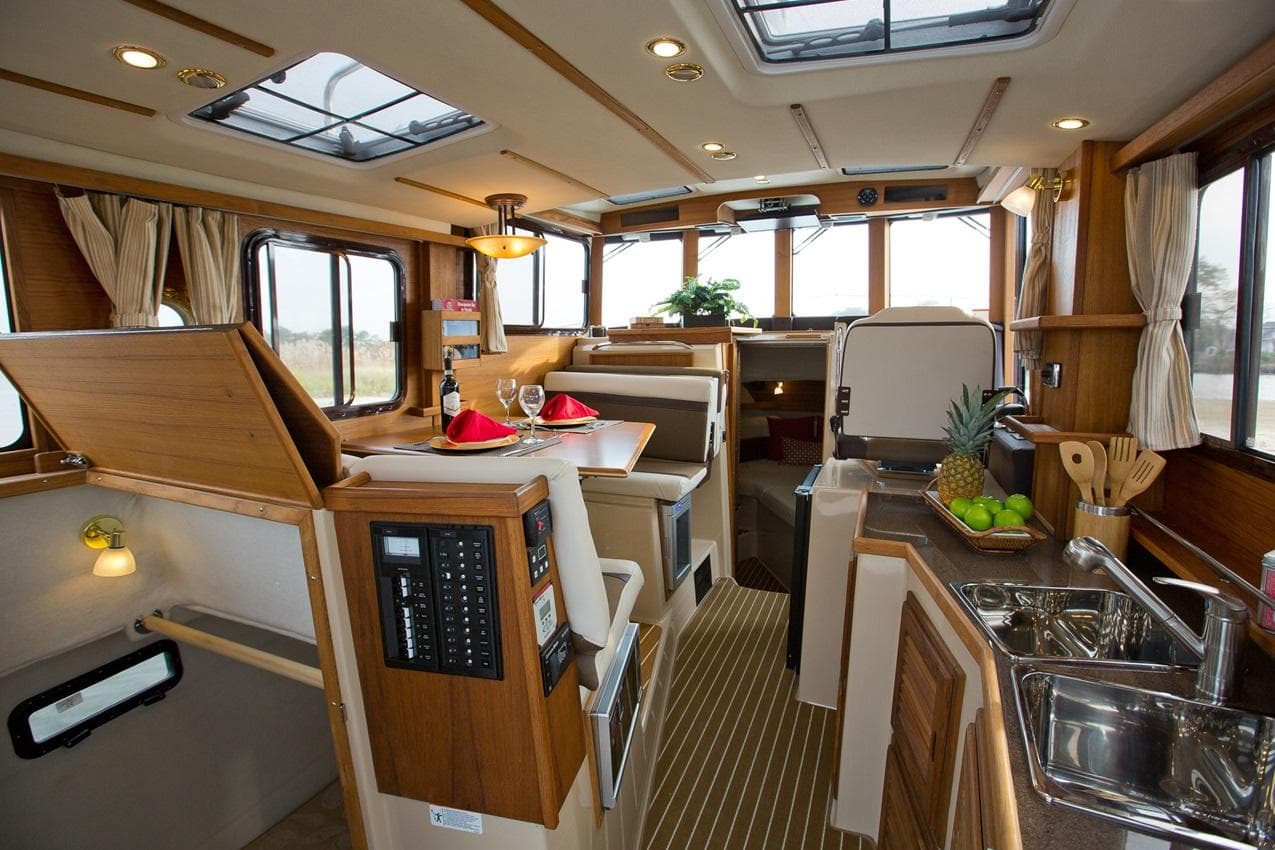 2024 Ranger Tugs R-31 Sedan Luxury Edition interior with dining area and kitchen.