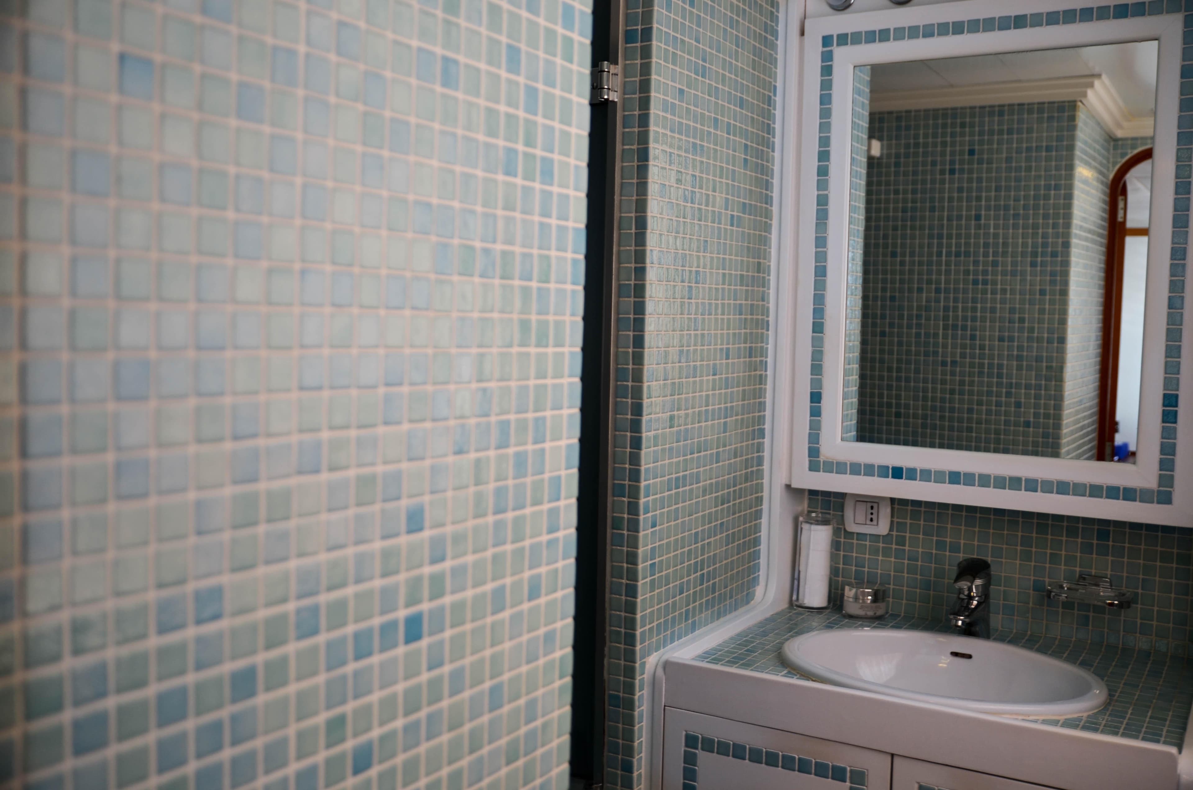 1974 Camper & Nicholsons Custom yacht bathroom with mosaic tiles and modern sink.