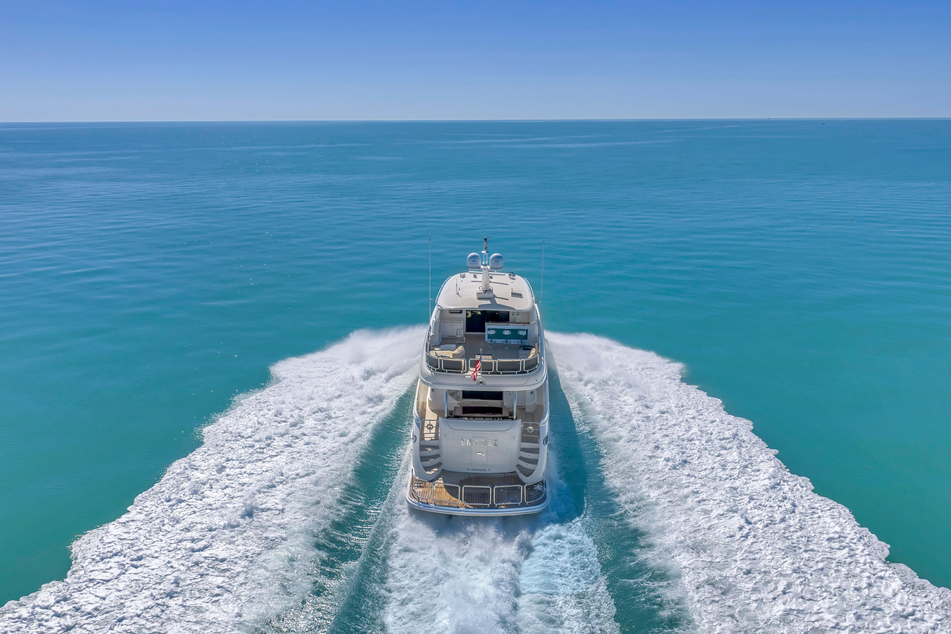 Luxurious 2015 Horizon E88 yacht cruising on clear blue ocean waters.