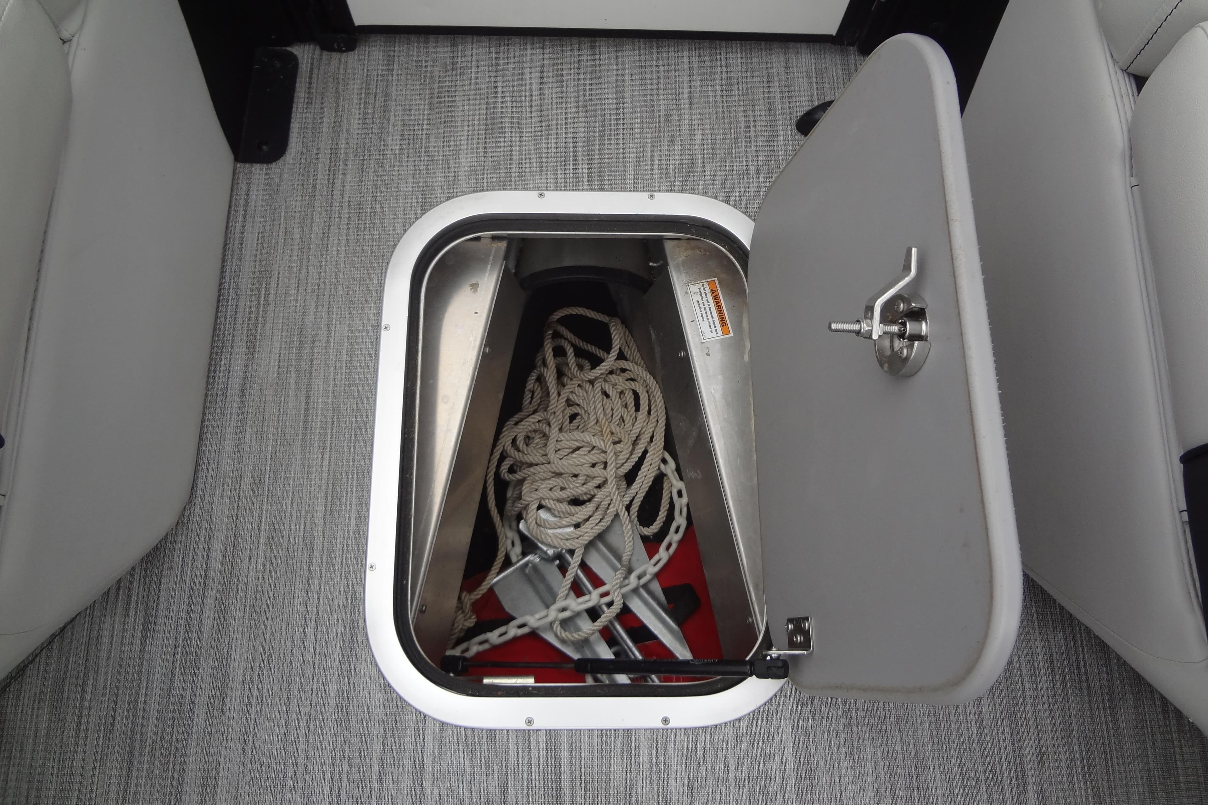 Open storage compartment on 2021 Baraletta Corsa 23 QSS boat with rope and anchor.