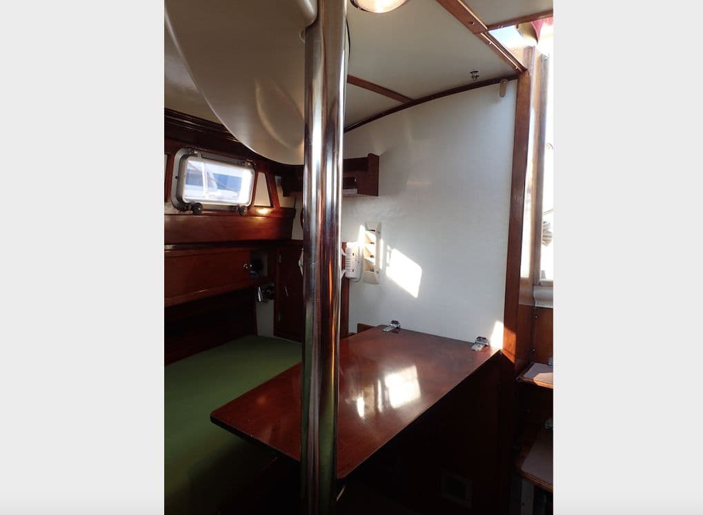 Interior of a 1975 Amel Euros 41 yacht with wooden furnishings.