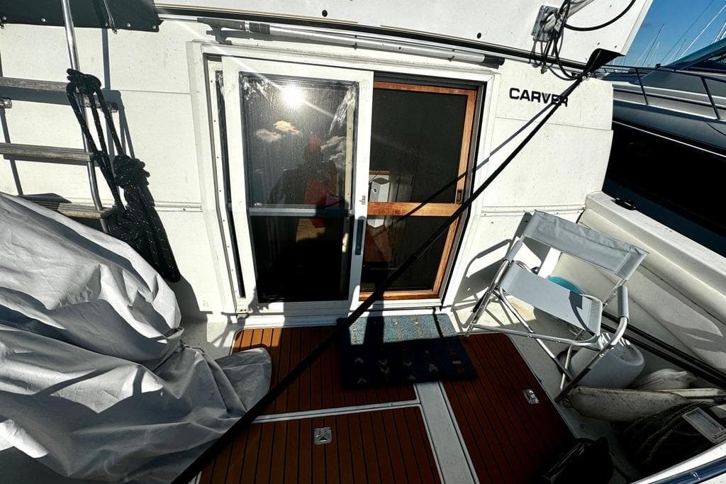 1991 Carver 430 Cockpit Motor Yacht deck with sliding door and seating area.