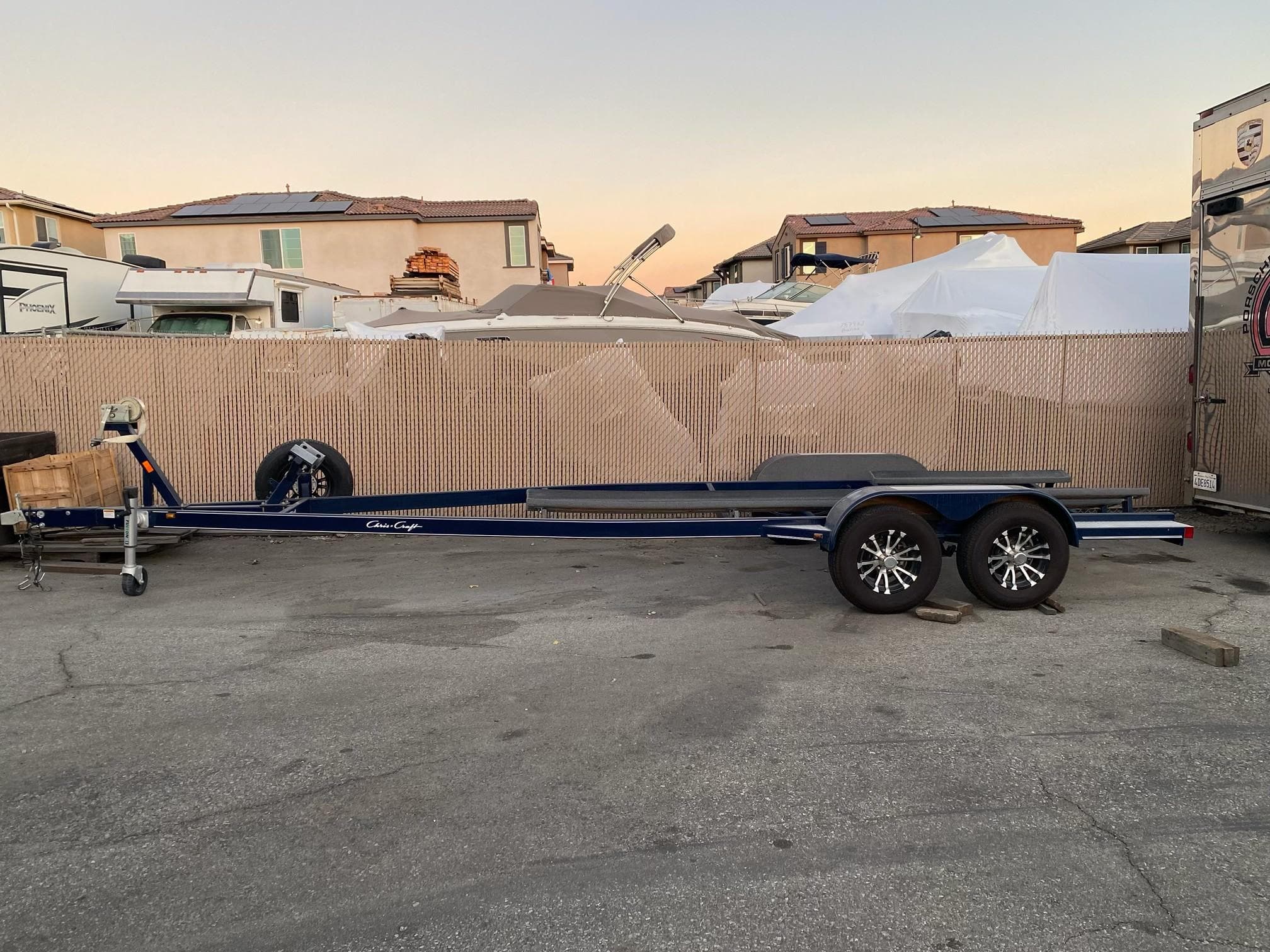 2020 Chris-Craft 25 Launch GT trailer parked in a residential area.