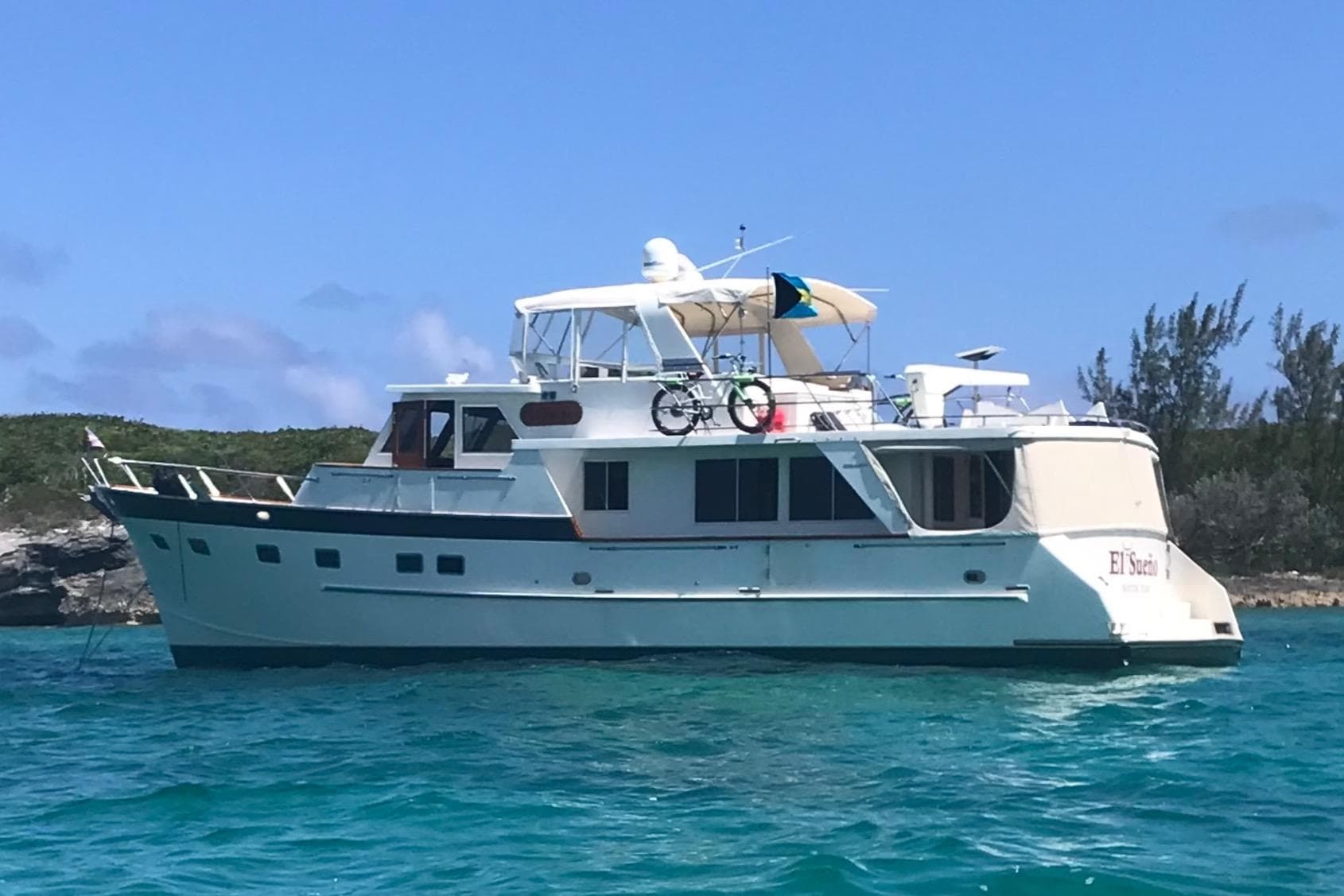Grand Alaskan 60 Pilothouse yacht, 1998 model, anchored in clear blue waters.