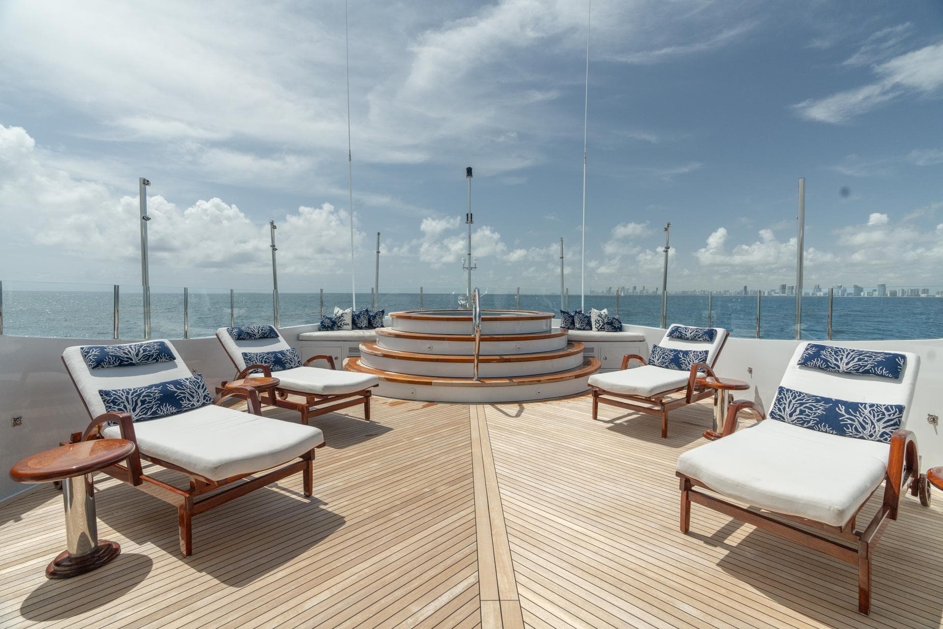 Luxurious deck of 2006 Trinity Tri-Deck Motor Yacht with sun loungers and ocean view.