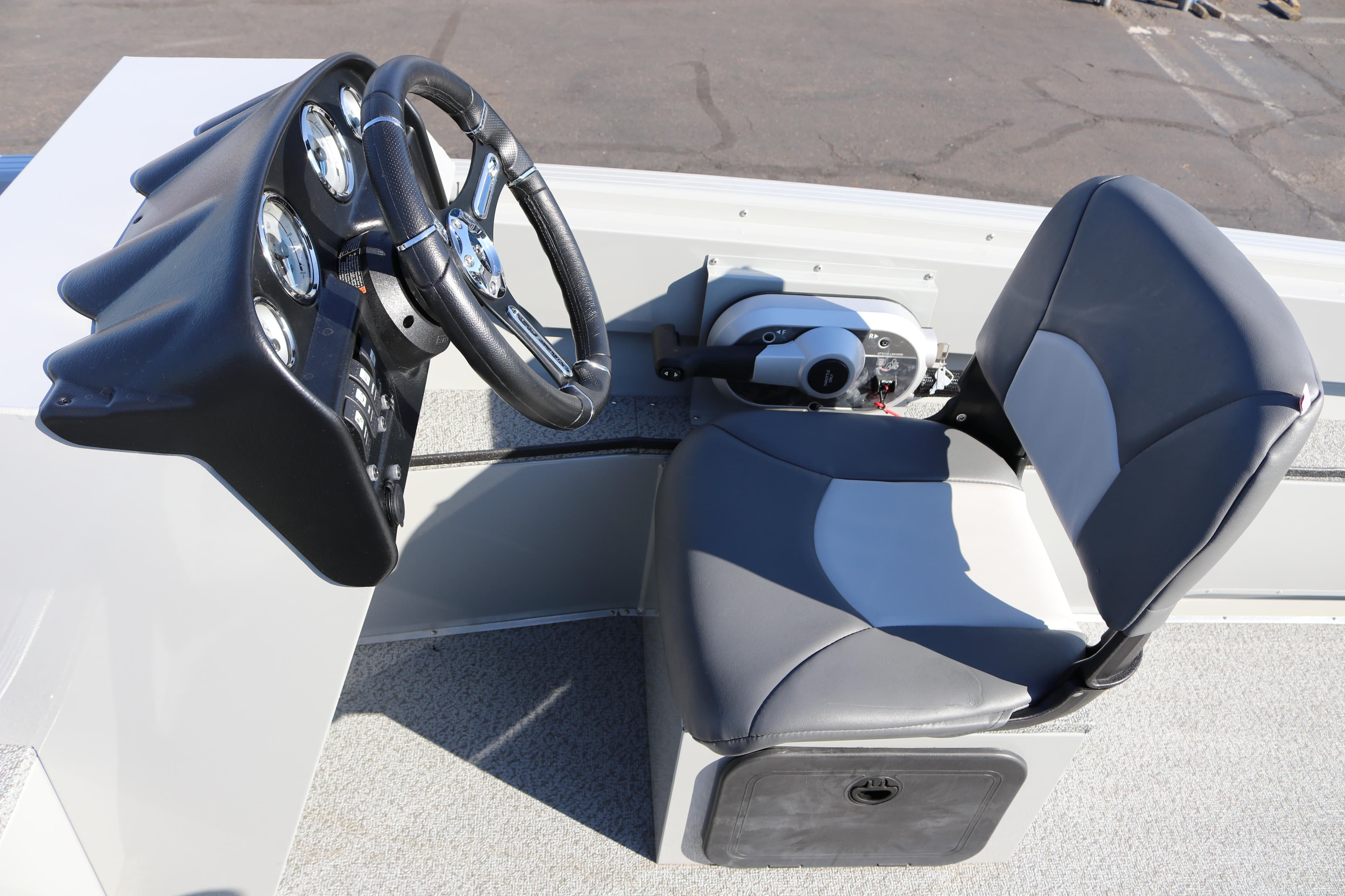 2025 Smoker Craft Pro Lodge 160 boat cockpit with steering wheel and seat.