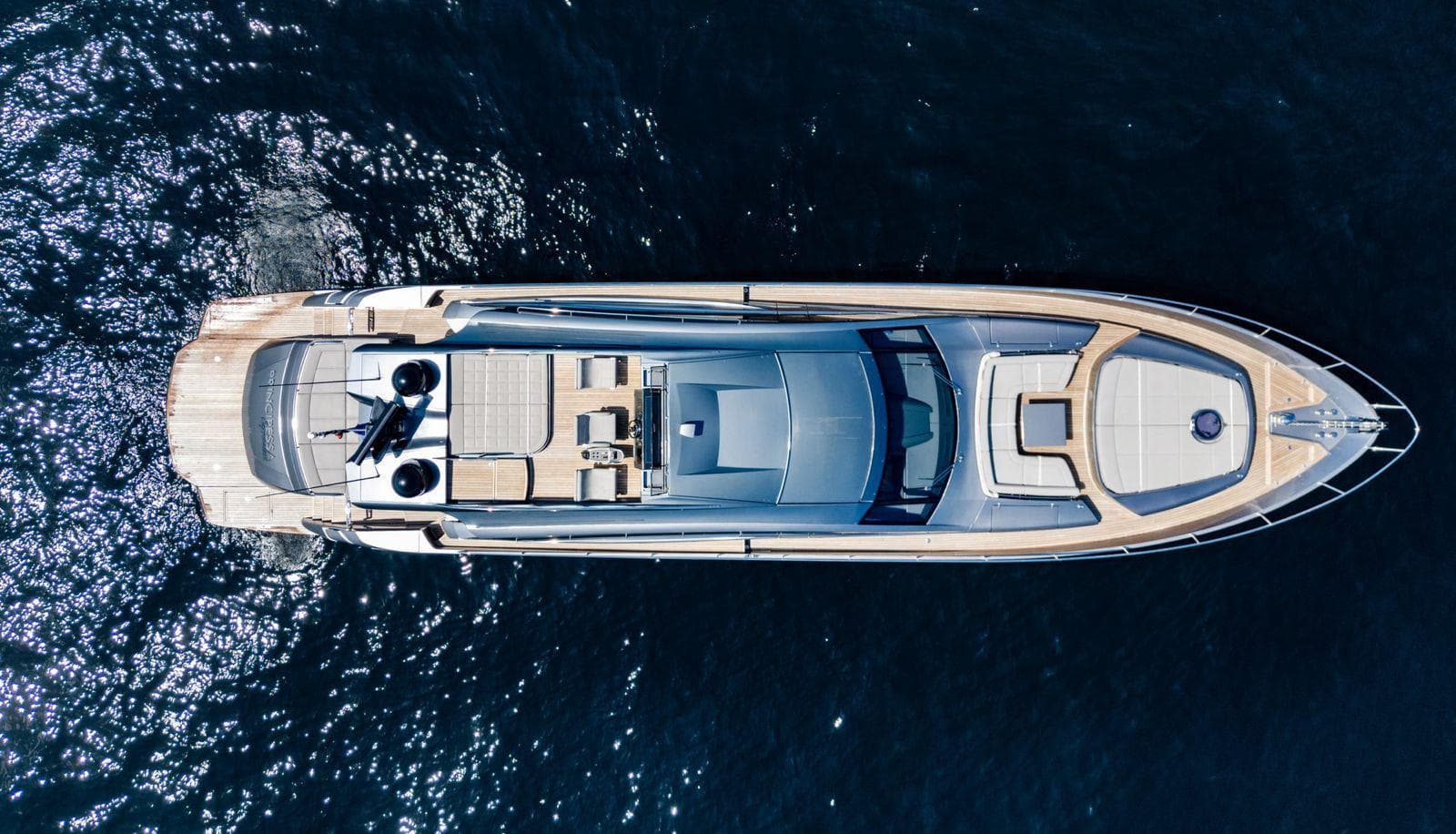 Aerial view of 2019 Pershing 82 yacht on dark blue water.