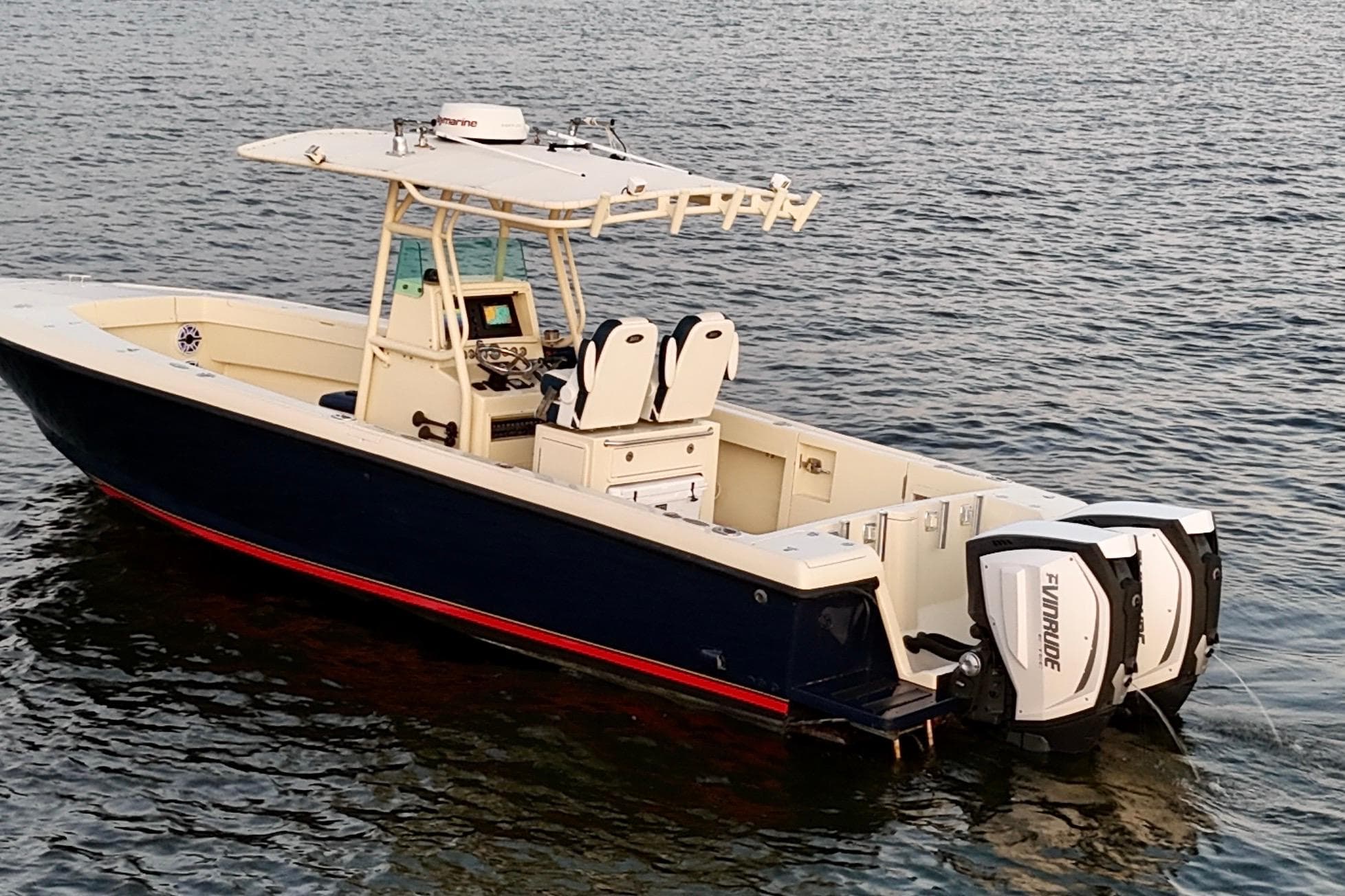 2003 Intrepid 289 Center Console boat on water, featuring dual Evinrude engines.