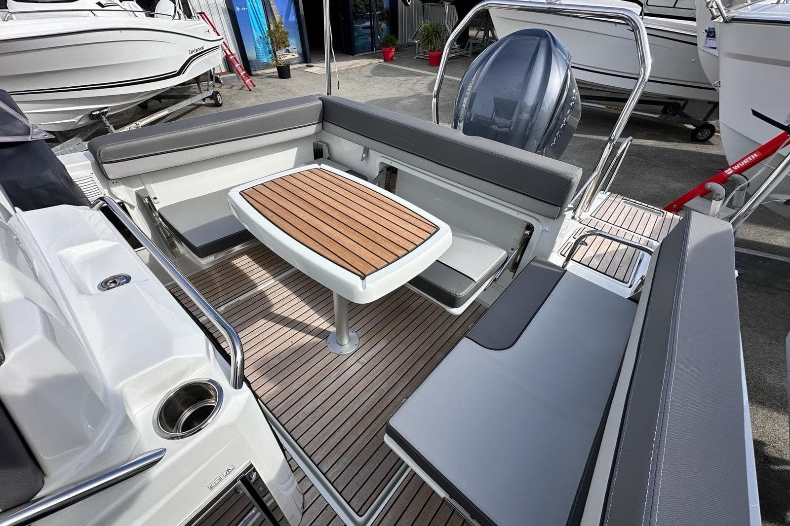 2025 Jeanneau Cap Camarat 7.5 WA Serie 3 boat interior with seating and wooden table.