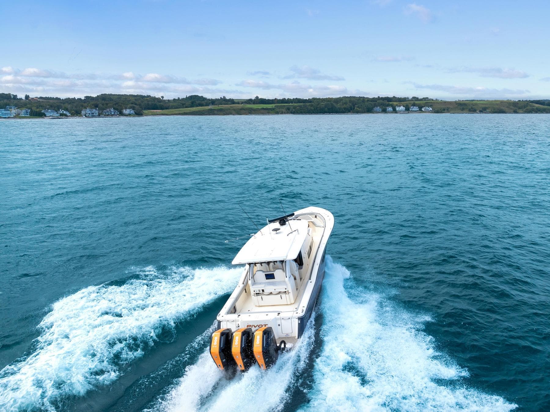 2023 Scout 425 LXF boat cruising on open water with scenic coastline.