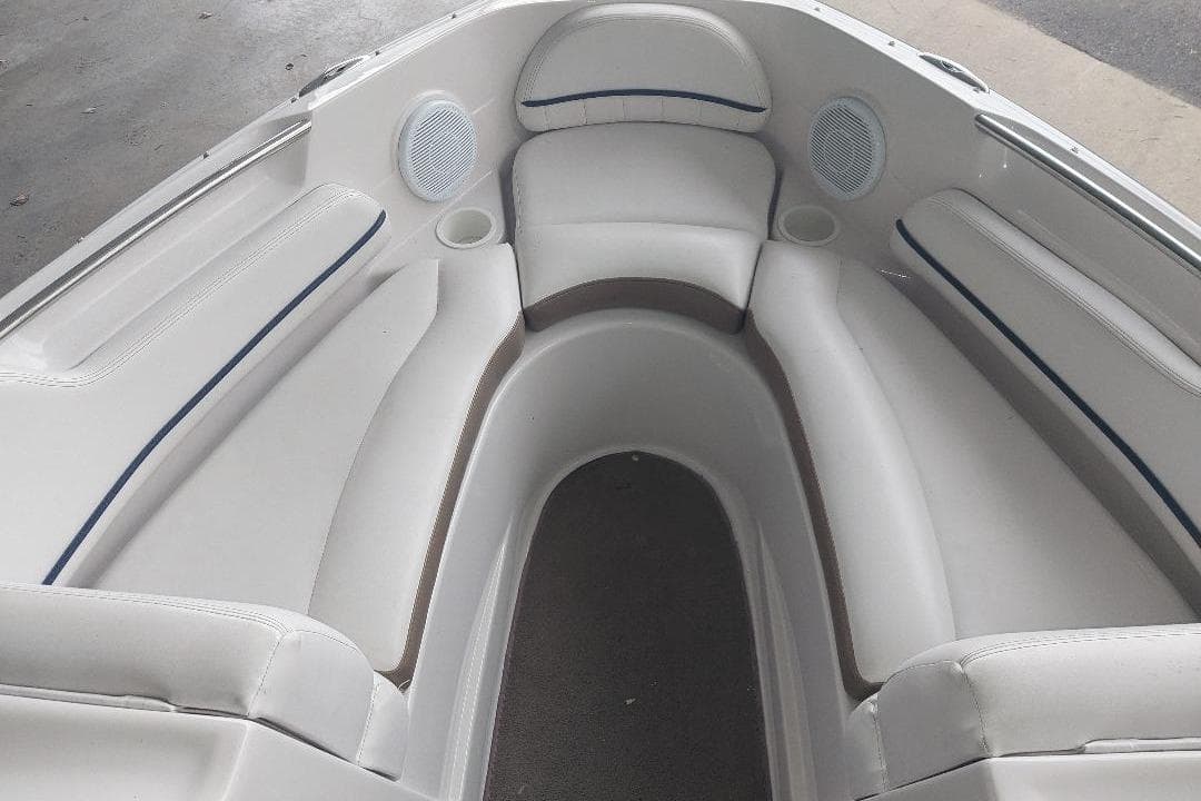 Interior of 2007 Four Winns 200 Horizon boat with white cushioned seating.