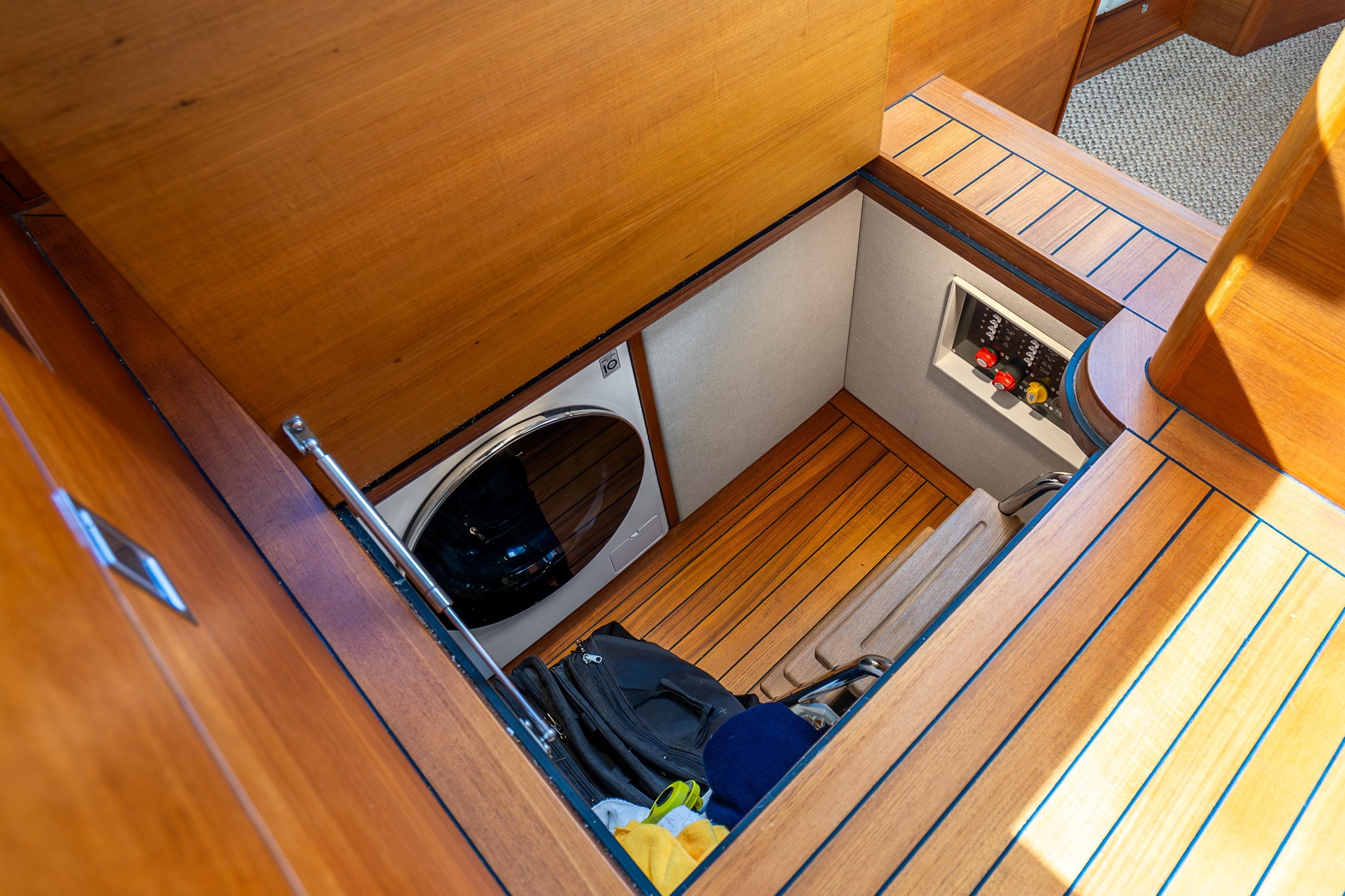 2020 Palm Beach Motor Yachts PB55 interior with laundry area and wooden flooring.