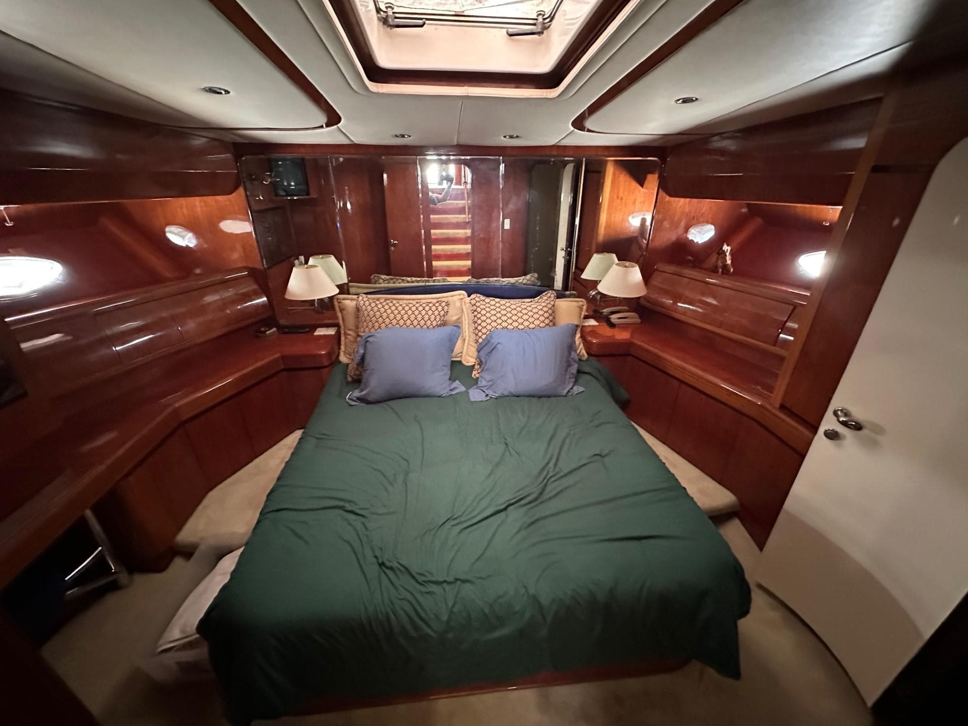 Luxurious cabin interior of 2001 Johnson 70 yacht with cozy bedding.