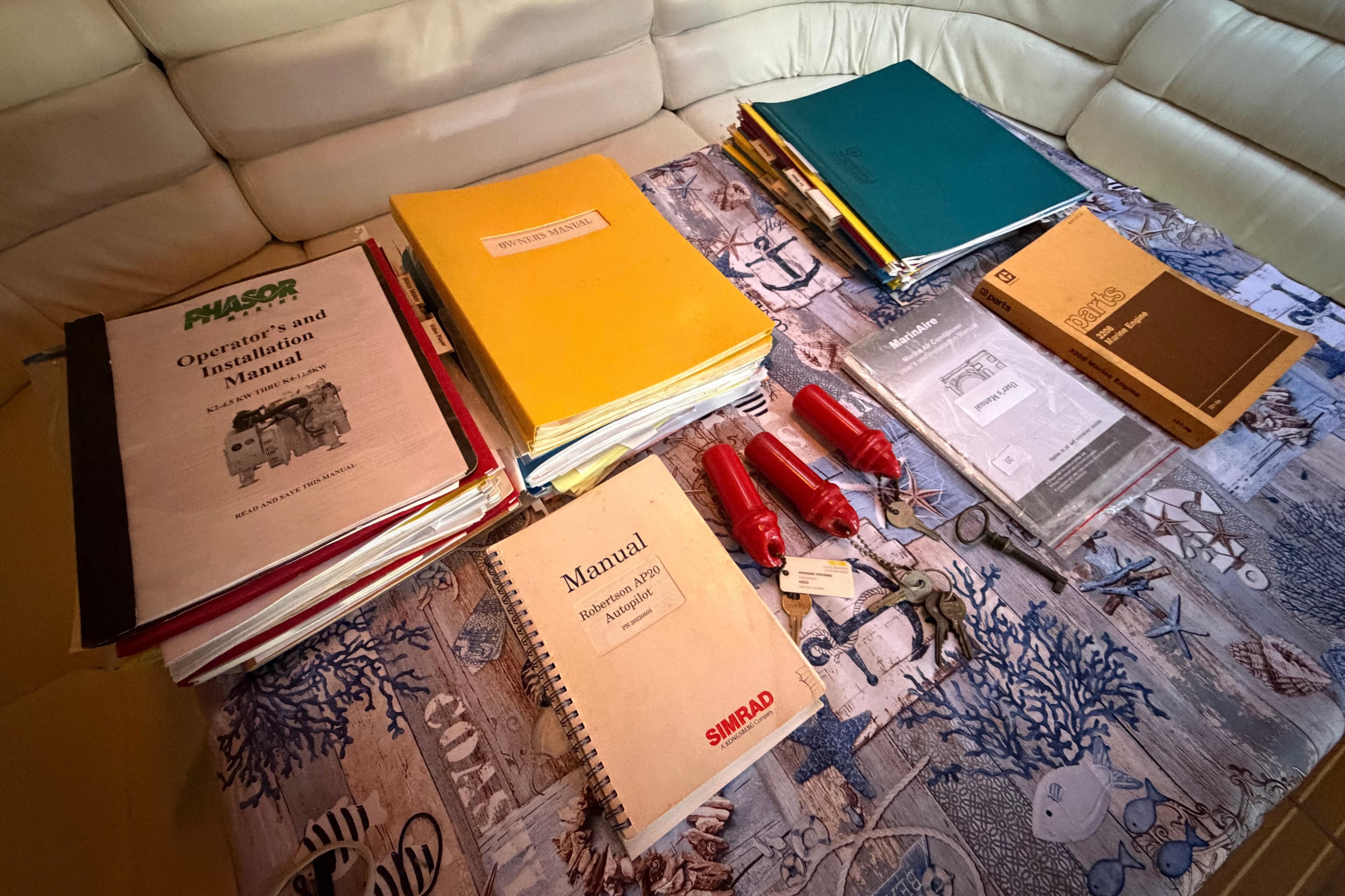 Manuals and documents on a table for a 1987 Hi-Star 55 Yacht Fisherman.