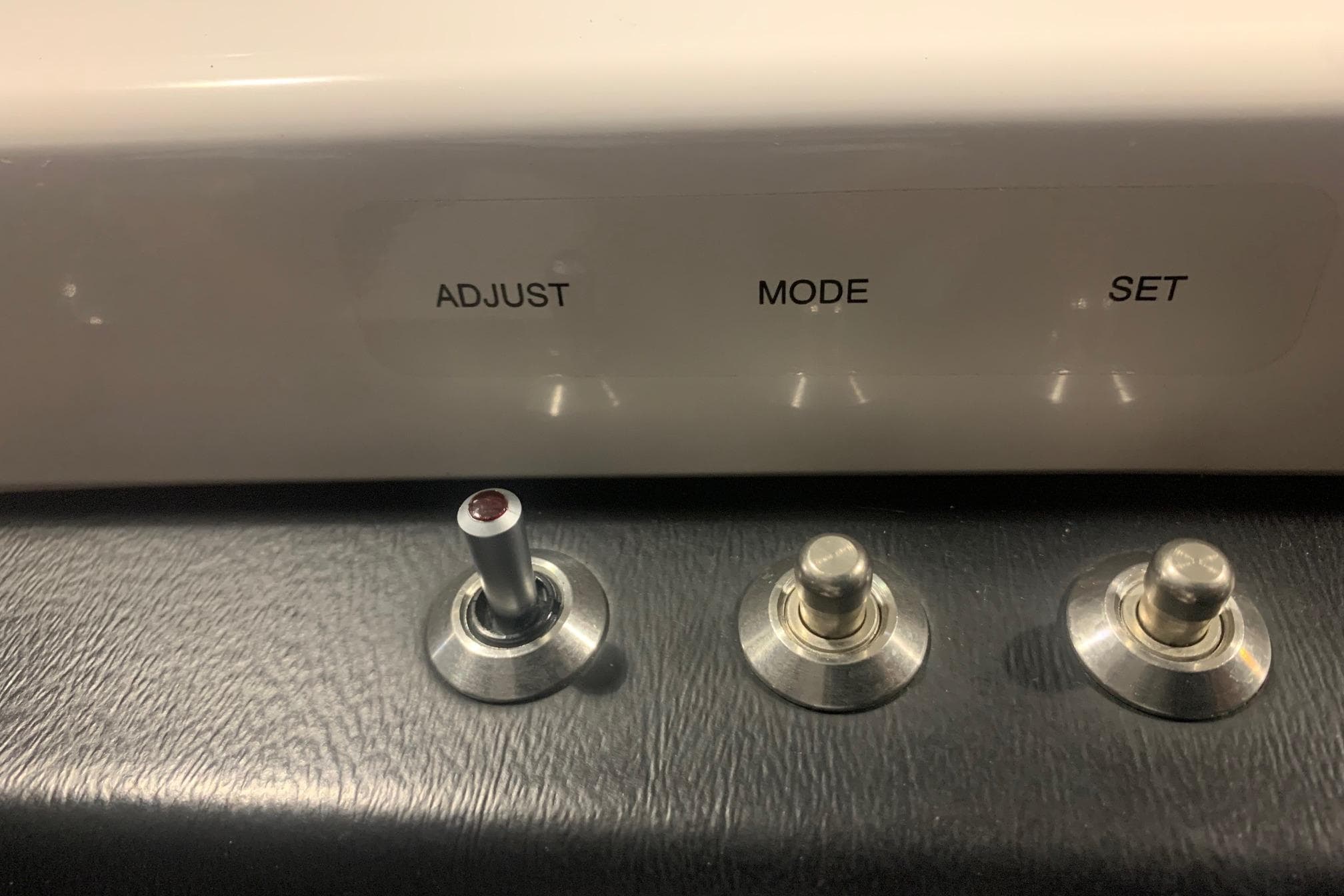 Control panel of 2019 Scarab 255 Wake ID with adjust, mode, set switches.