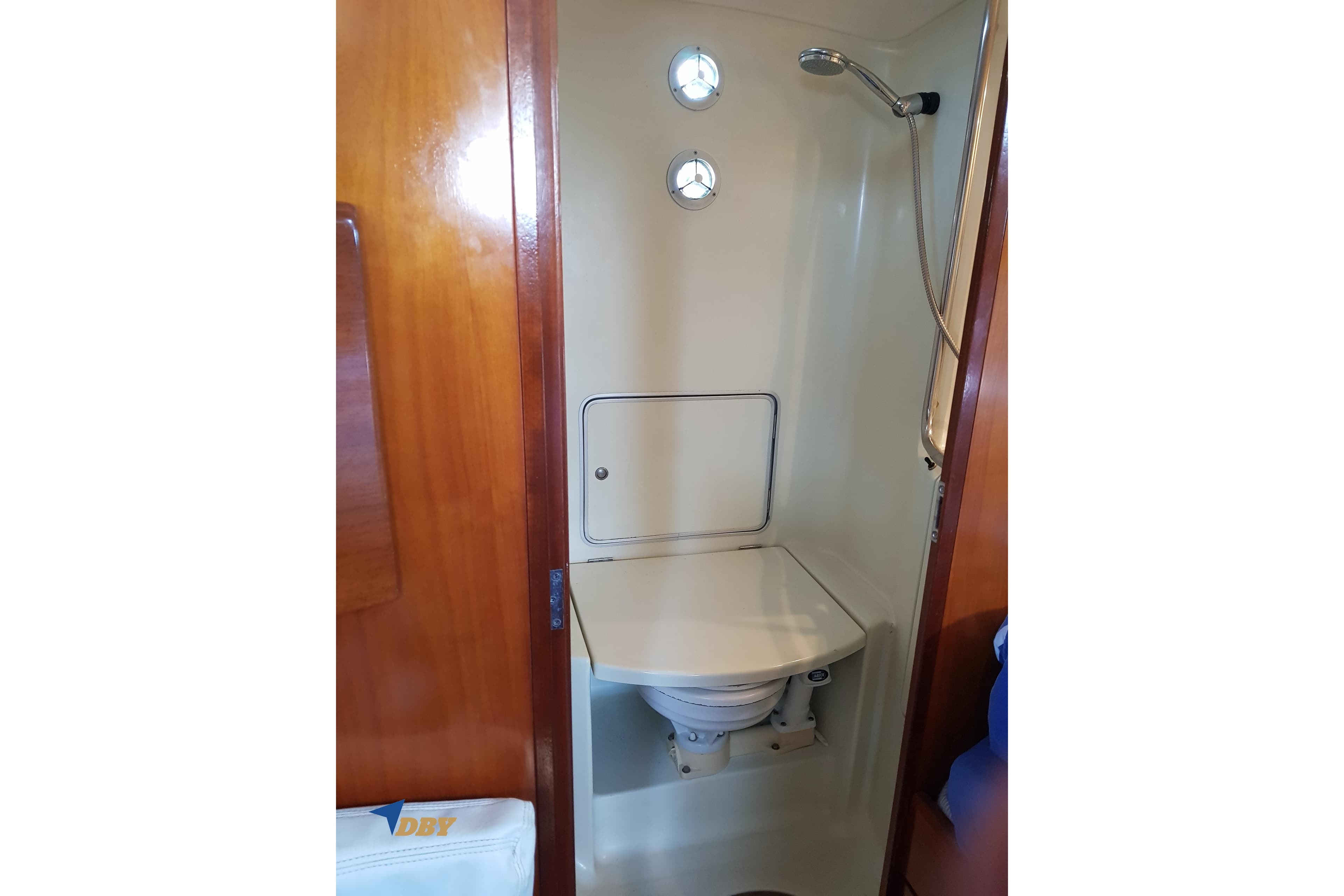 Bathroom interior of 1993 Beneteau First 45f5 yacht, featuring shower and toilet.